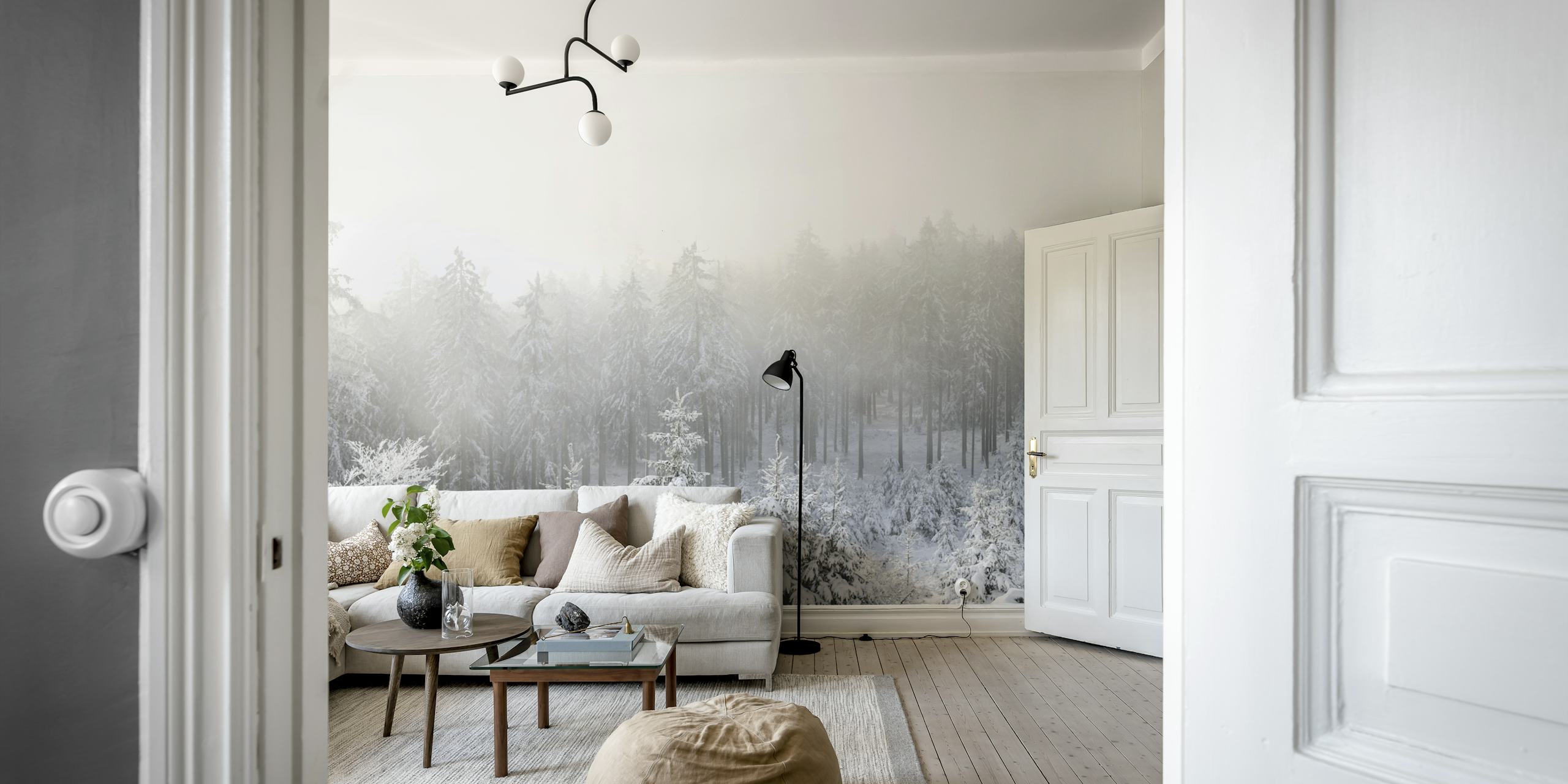 Snow-covered trees in a foggy landscape wallpaper.