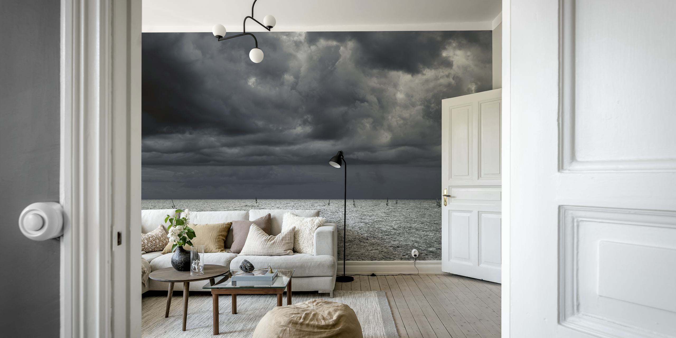 Moody seascape with cloudy sky over a shimmering ocean wall mural