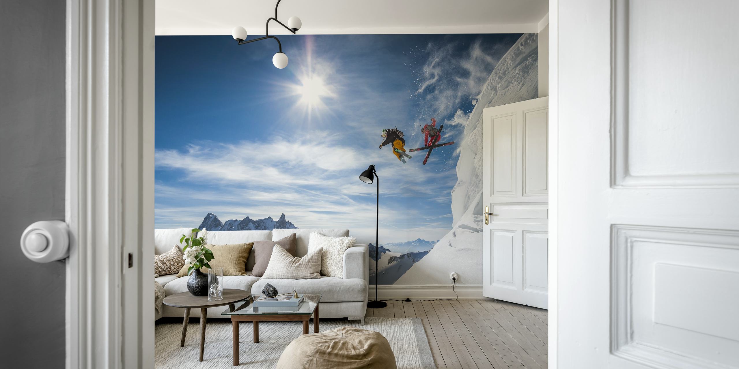 Two skiers jumping over snowy mountains with a bright blue sky, action-packed wallpaper