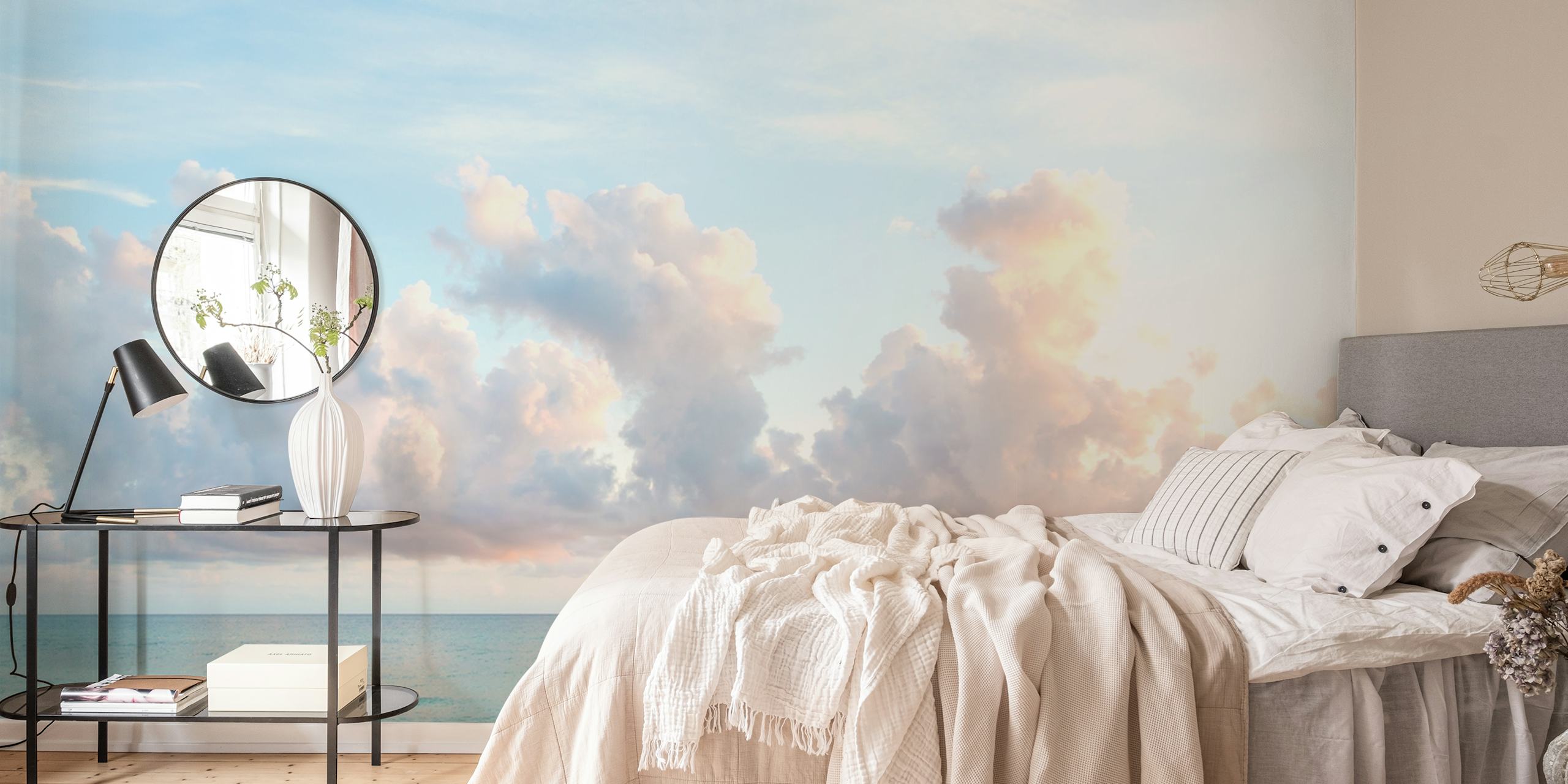 Blue ocean with gentle waves and soft pink clouds wallpaper