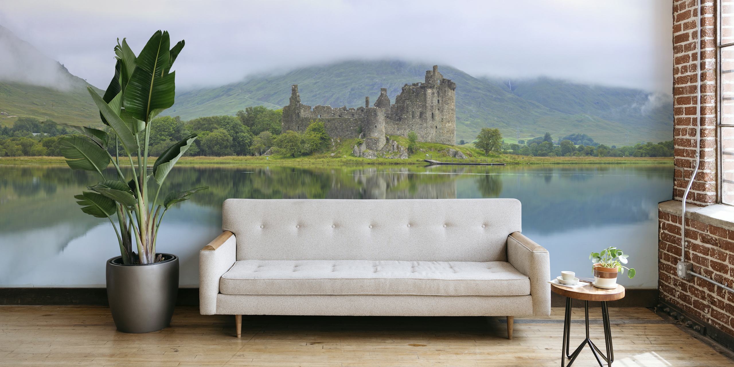 Kilchurn Castle reflecting in tranquil water surrounded by green hills wallpaper