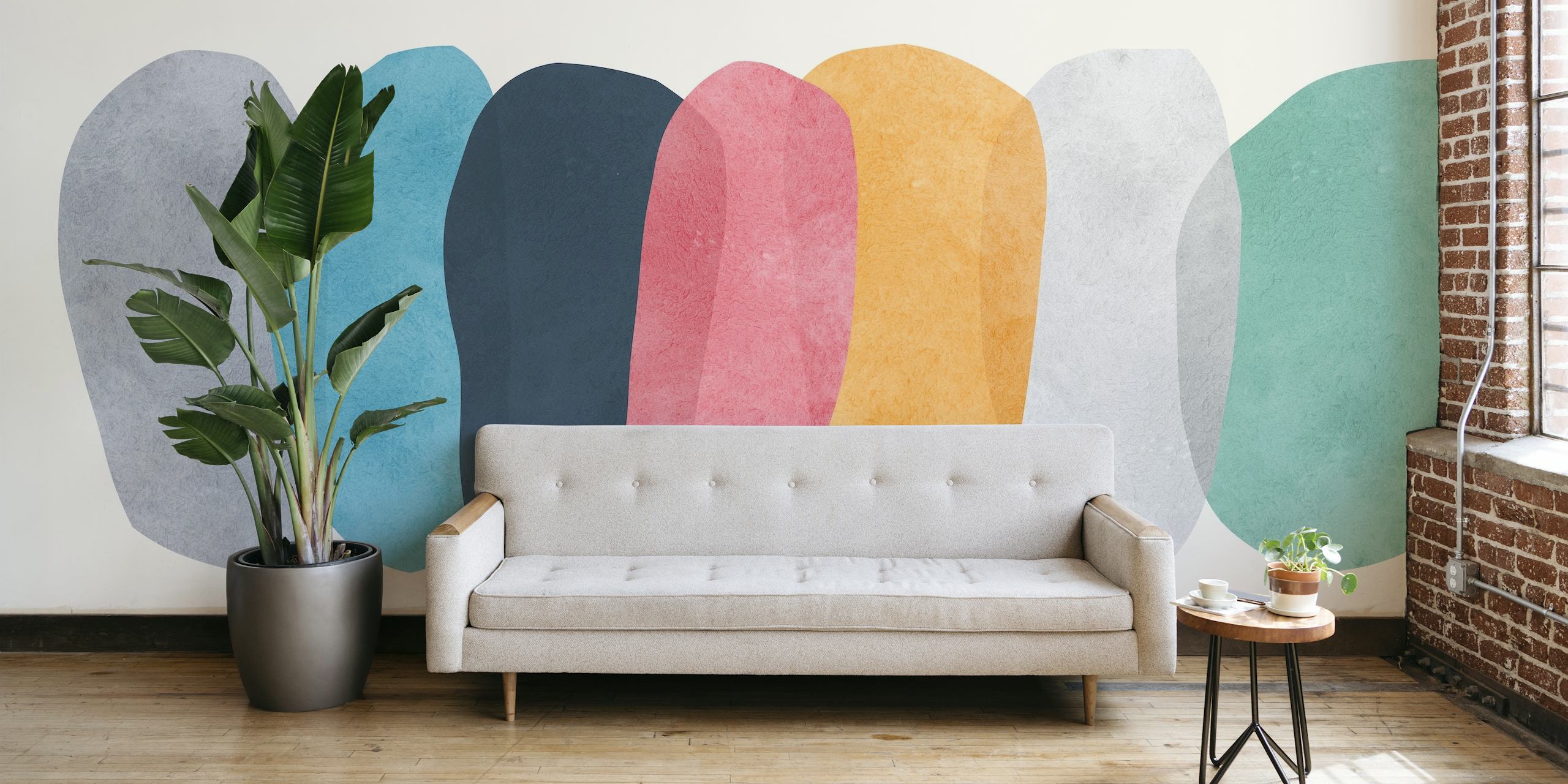 Abstract wall mural with elliptical shapes in muted colors featuring blue and yellow accents