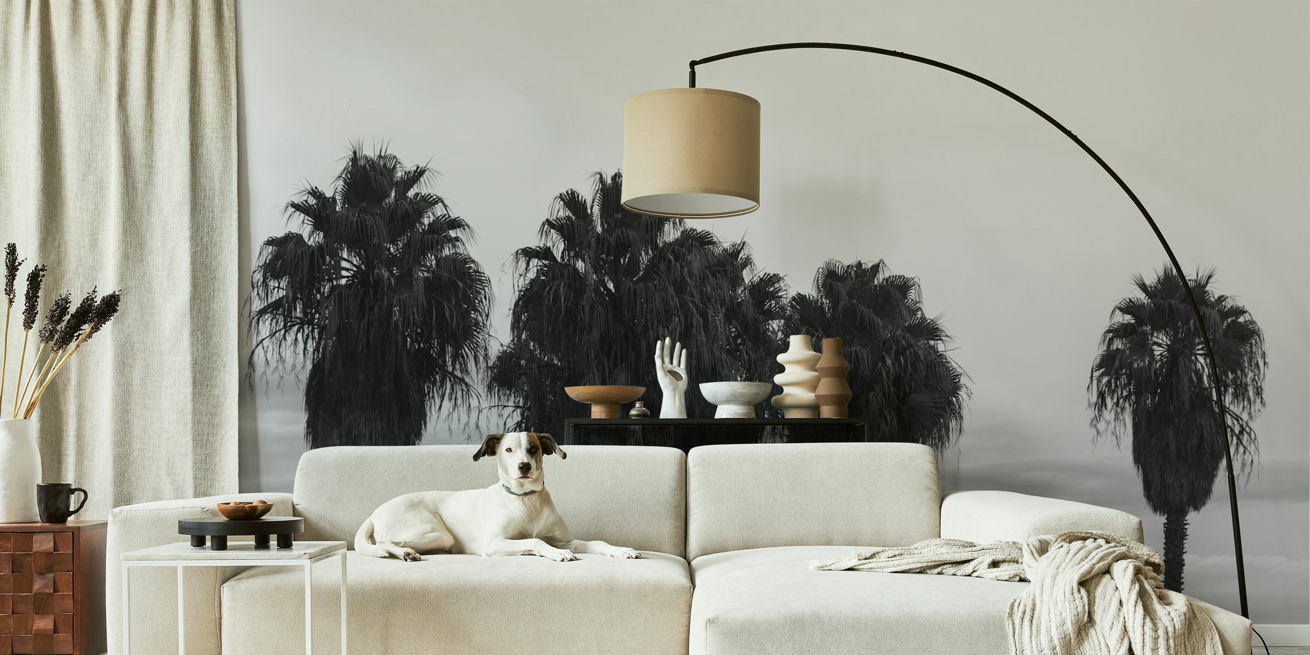 Black and white wall mural featuring a row of palm trees against a misty background, evoking a calm evening ambience