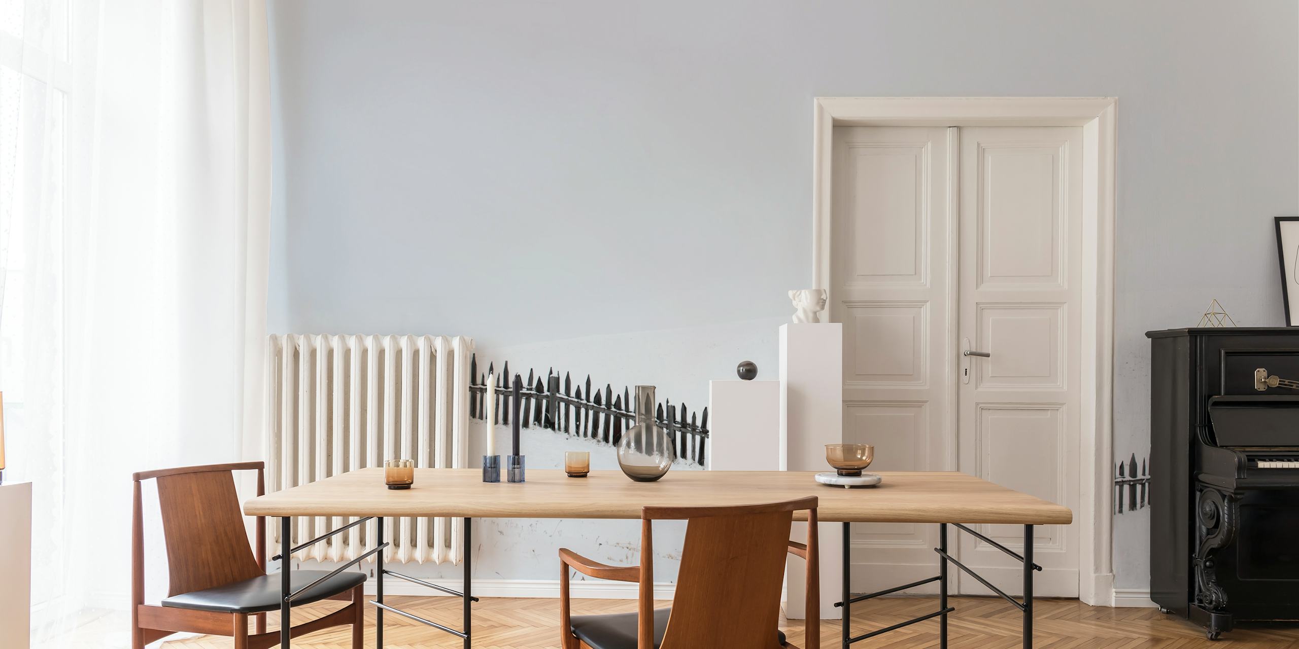 Minimalist snowy landscape with a lone tree and wooden fence wallpaper