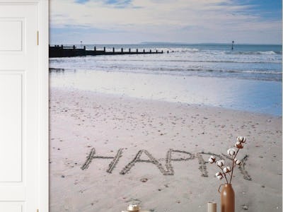 HAPPY written on beach