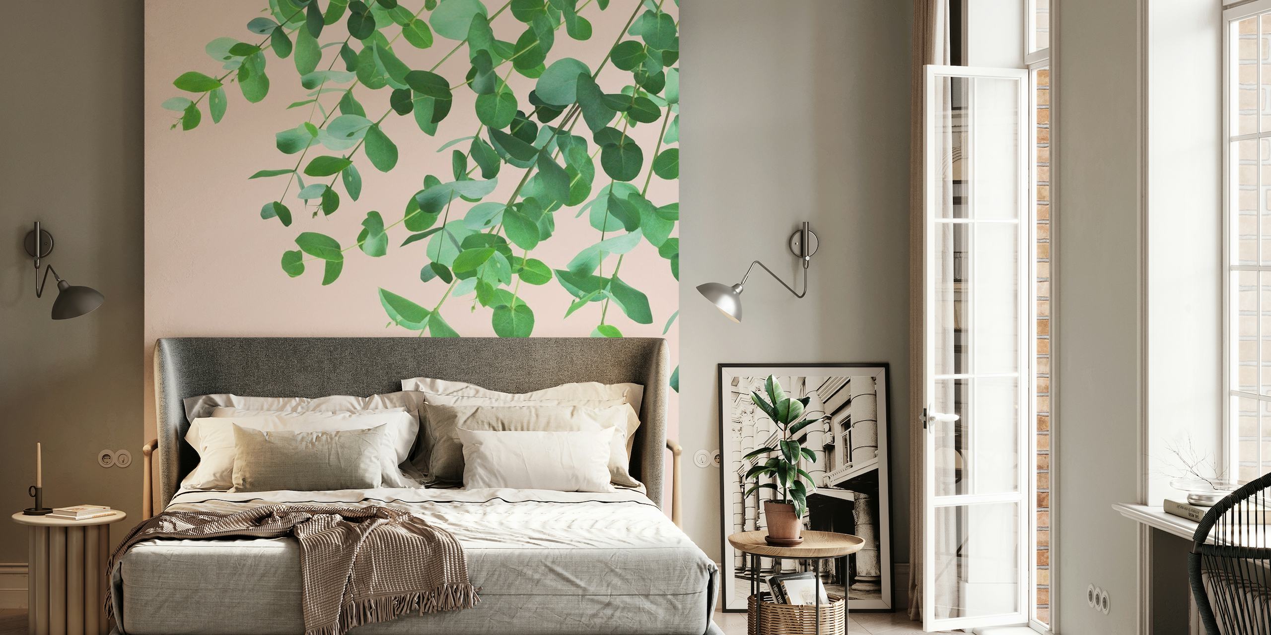 Eucalyptus branches with lush green leaves against a blush pink background wall mural