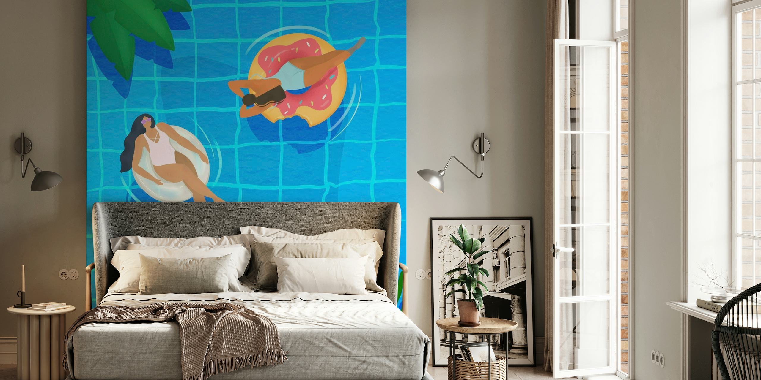 Stylish women lounging on pool inflatables in a clear blue pool with tropical elements, in a wall mural