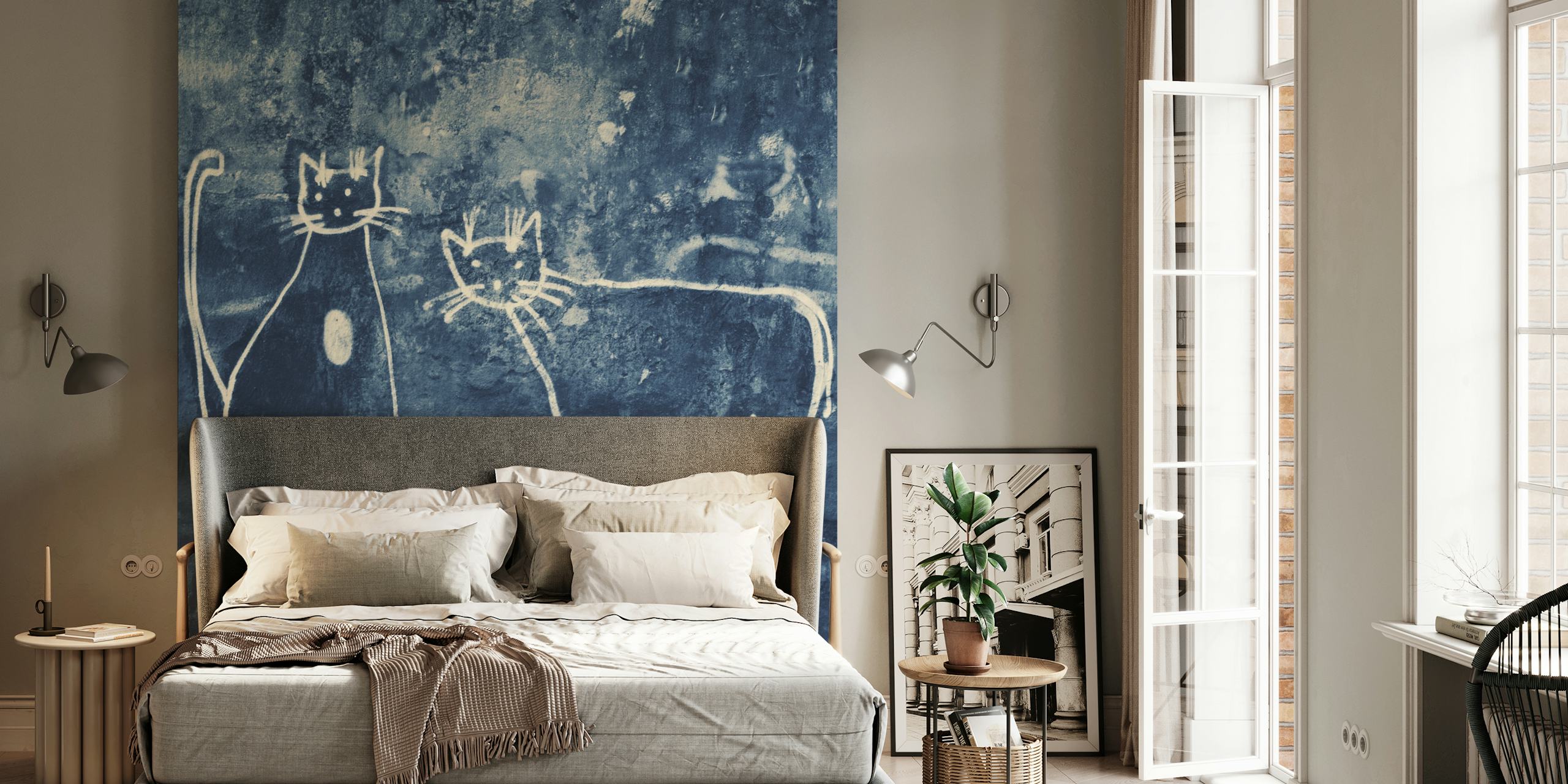 Two white graffiti cats on a dark blue textured wall mural