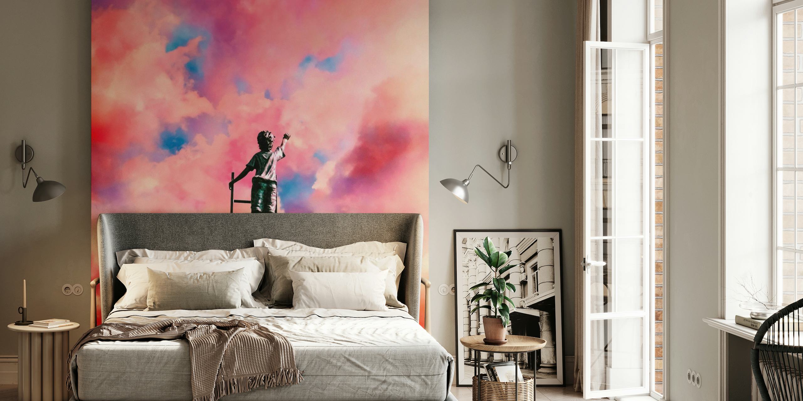 Whimsical wall mural of an artist painting the clouds from a ladder in a vibrant sky
