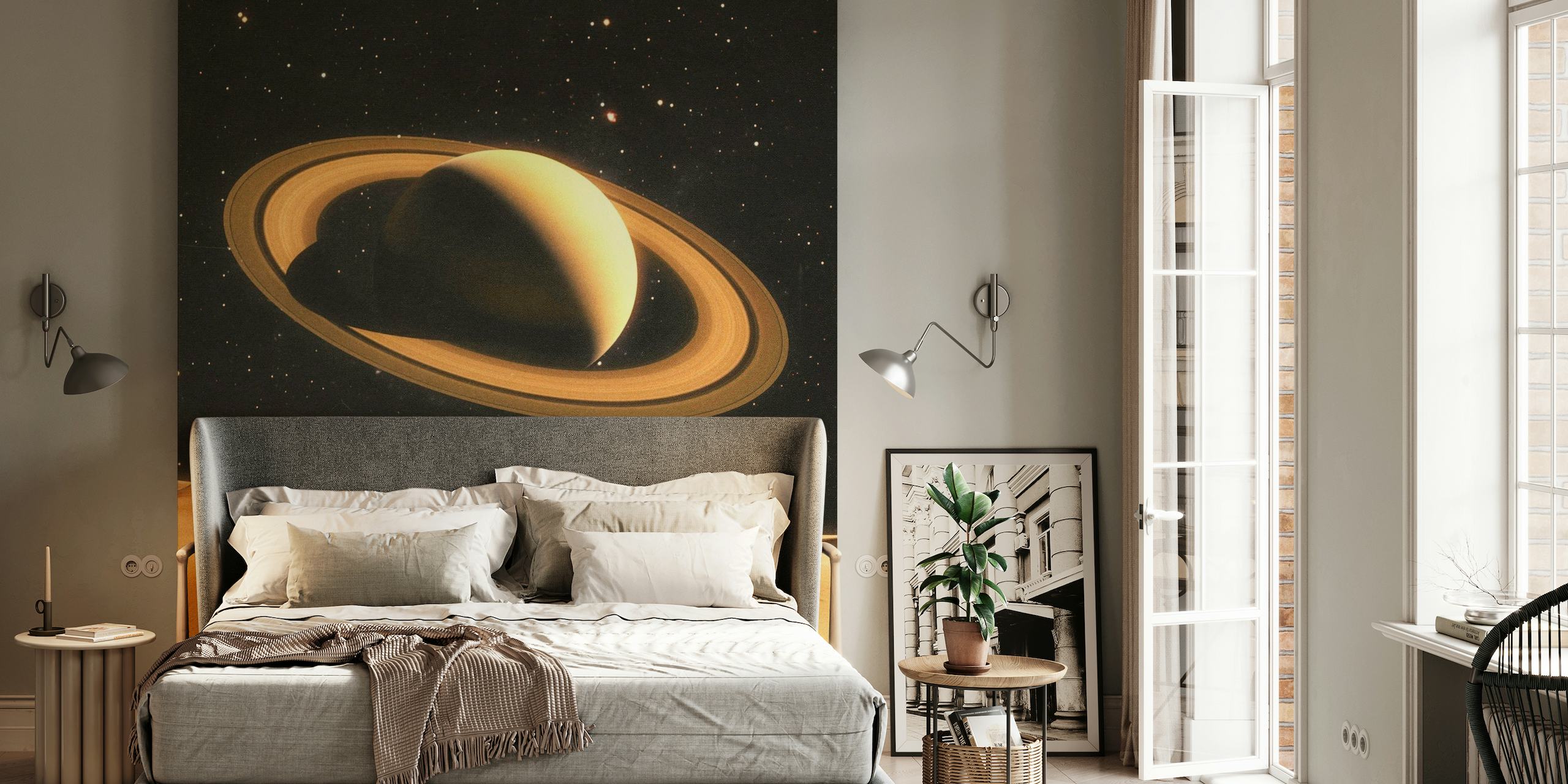 Mural de dos personas en un planeta desértico con Saturno de fondo