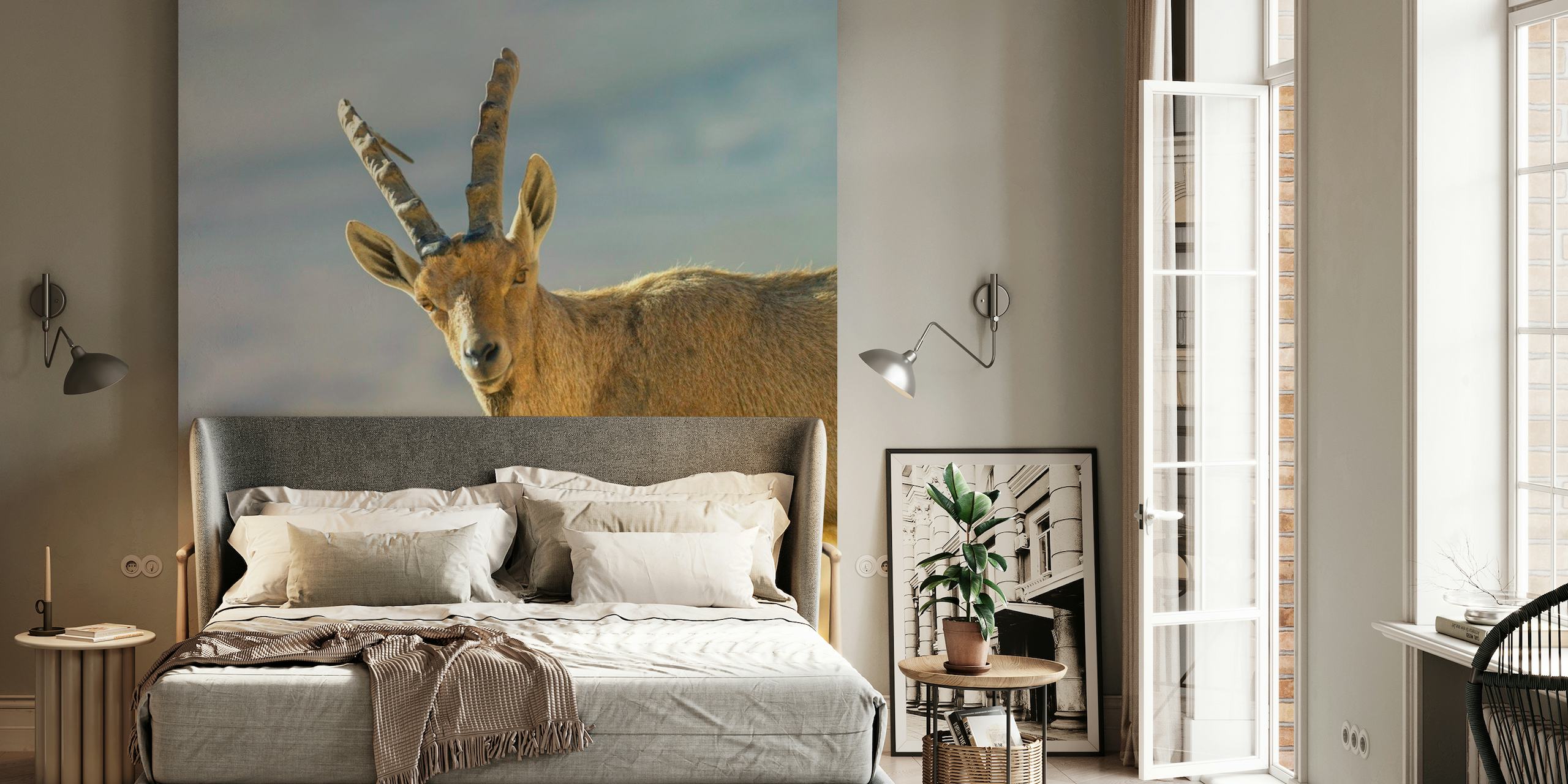 Mountain goat standing on a peak wall mural