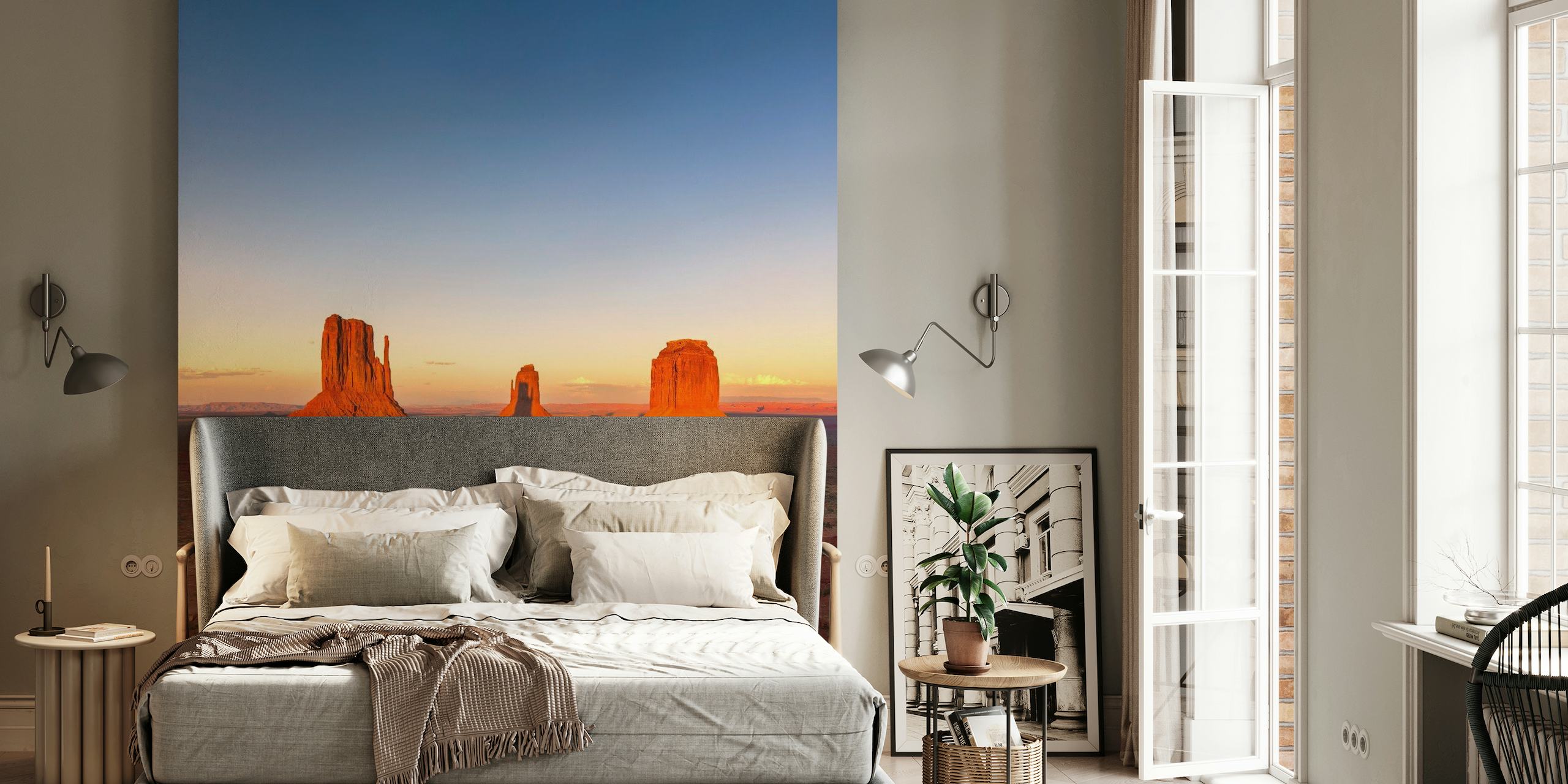 Desert sunset wall mural with landforms casts in amber
