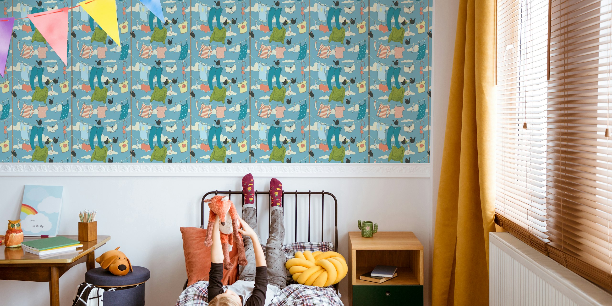 Clothes hung on a line with birds and clouds in blue background wallpaper