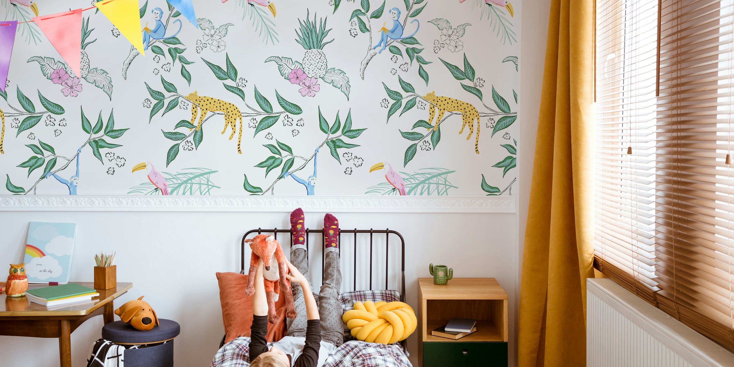 Tropical jungle design with monkeys, leopards, and pink birds on a cream background wallpaper