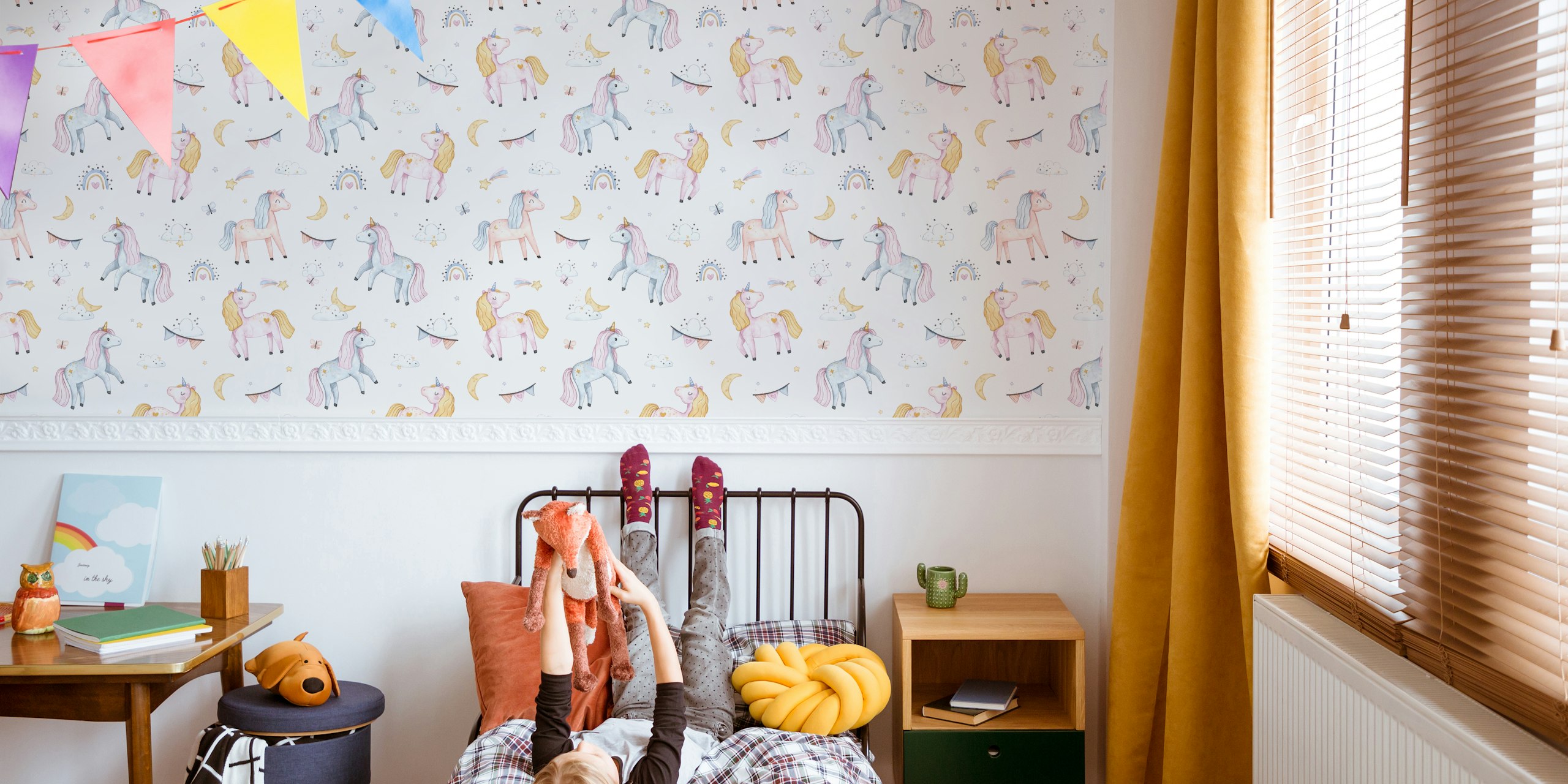 Pink unicorns, clouds, rainbows, stars on light pink wallpaper