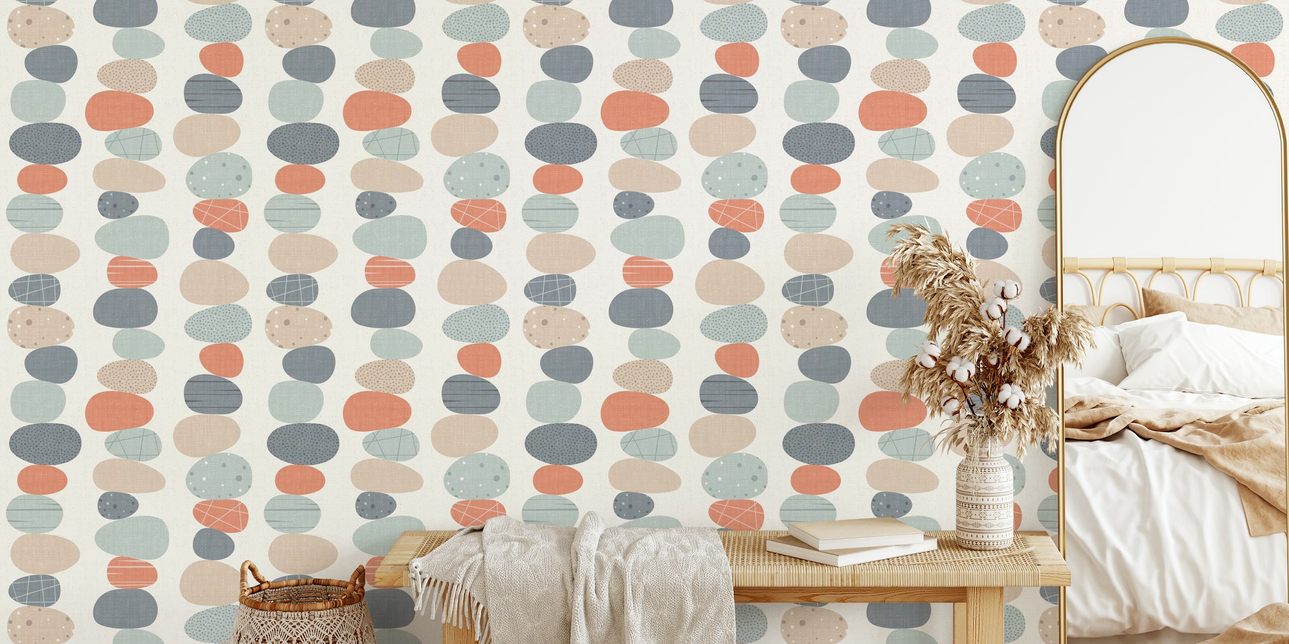 Colorful pebble stones in soft pastels on cream wallpaper