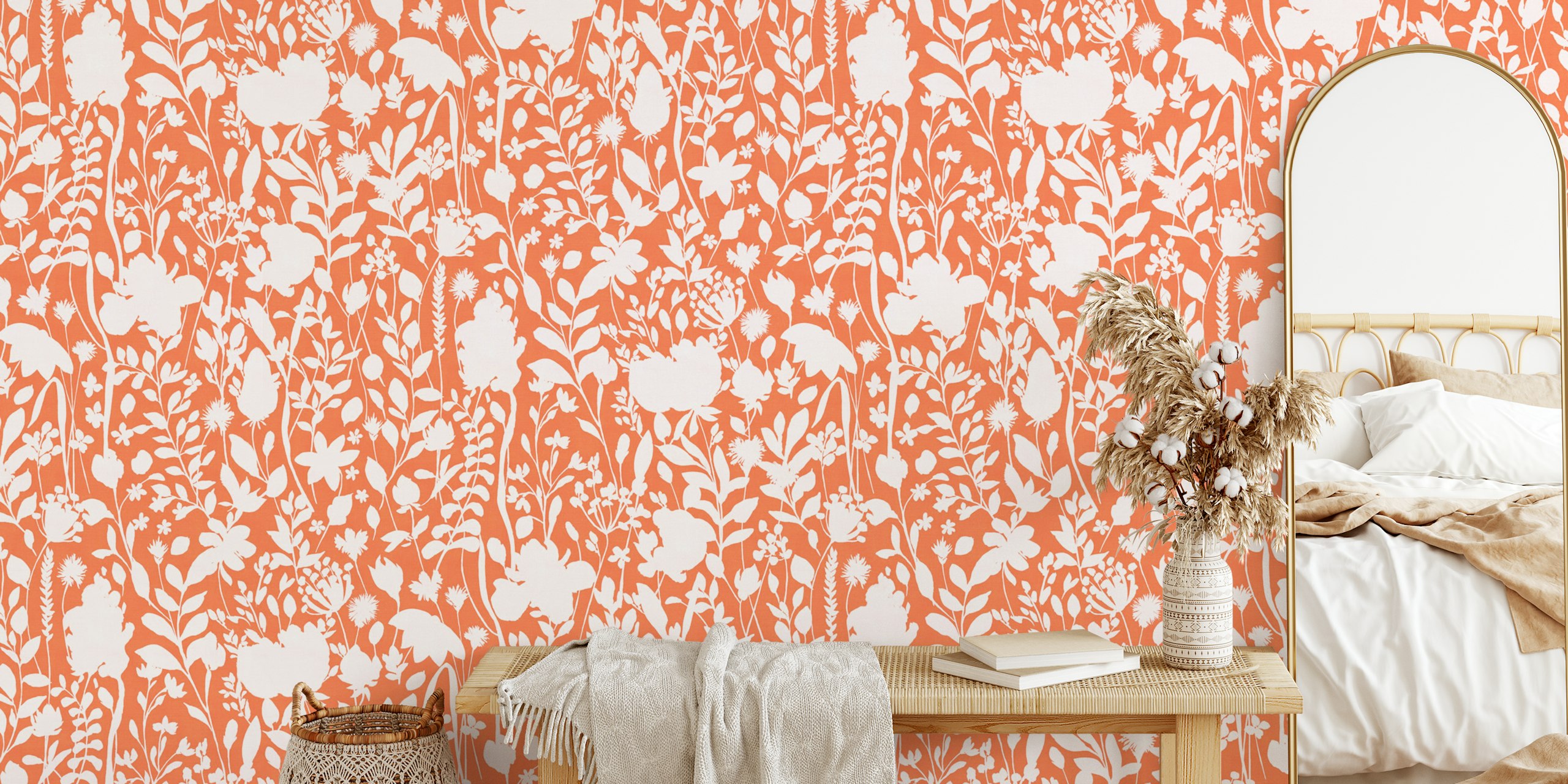 Floral silhouettes in white against an orange background wallpaper