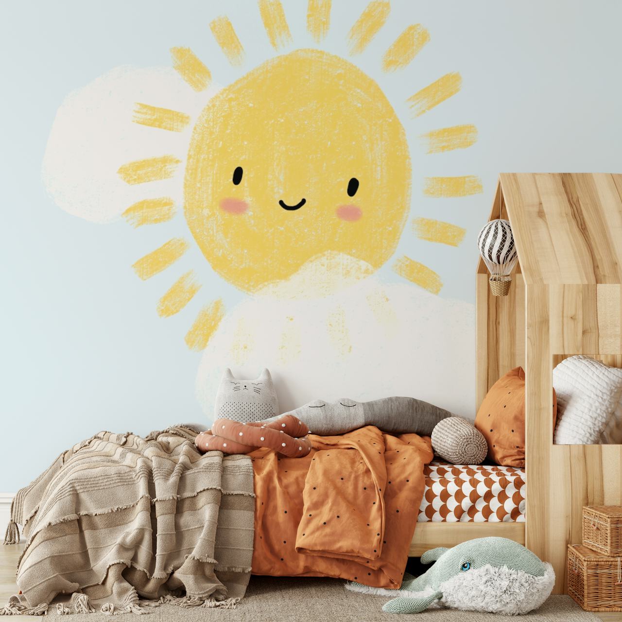 Smiling sun with rays and fluffy clouds on blue background wallpaper