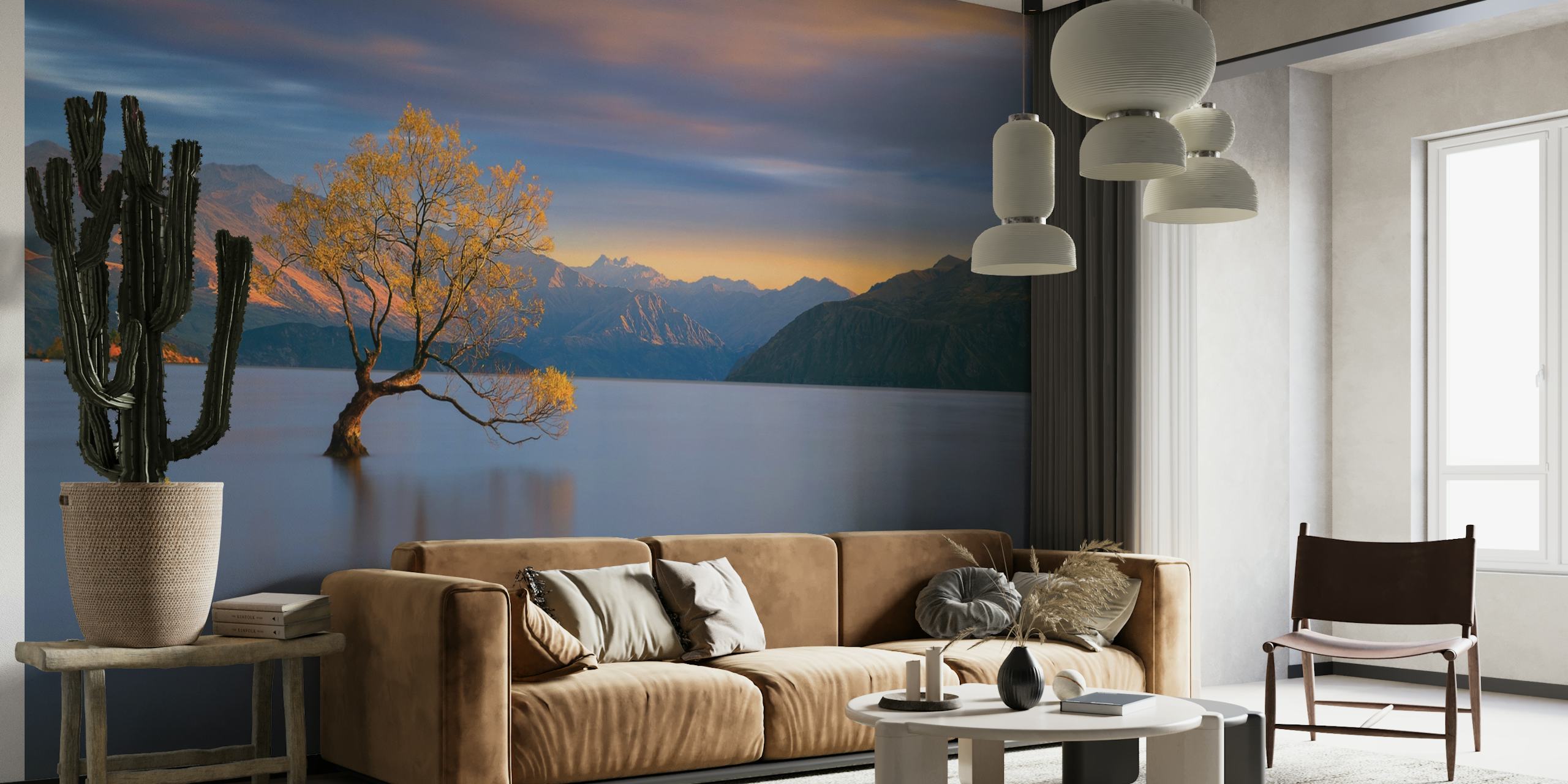 Solitary tree in tranquil lake with mountains at sunrise wall mural