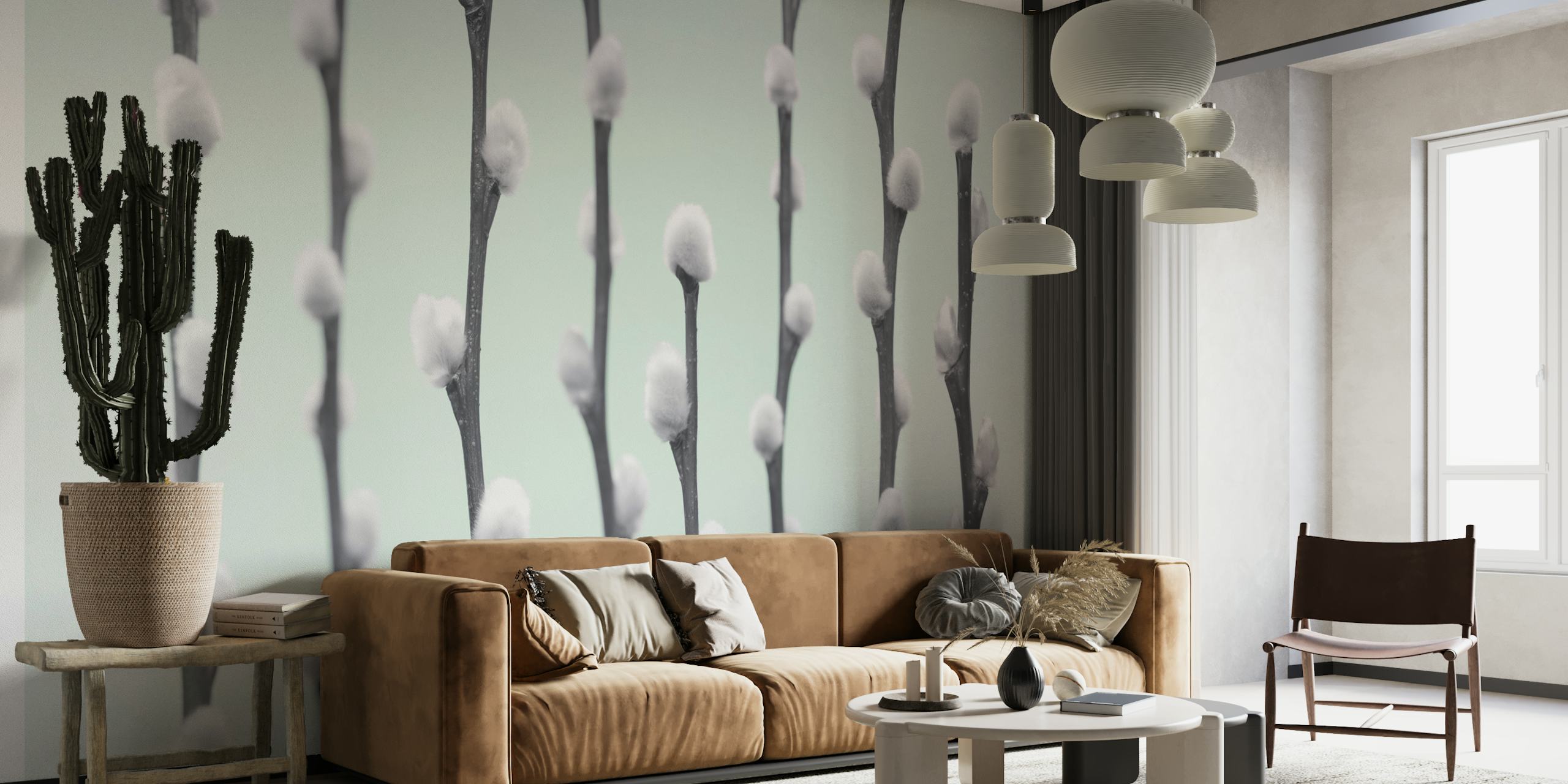 White pussy willow twigs with fluffy buds on light mint wallpaper