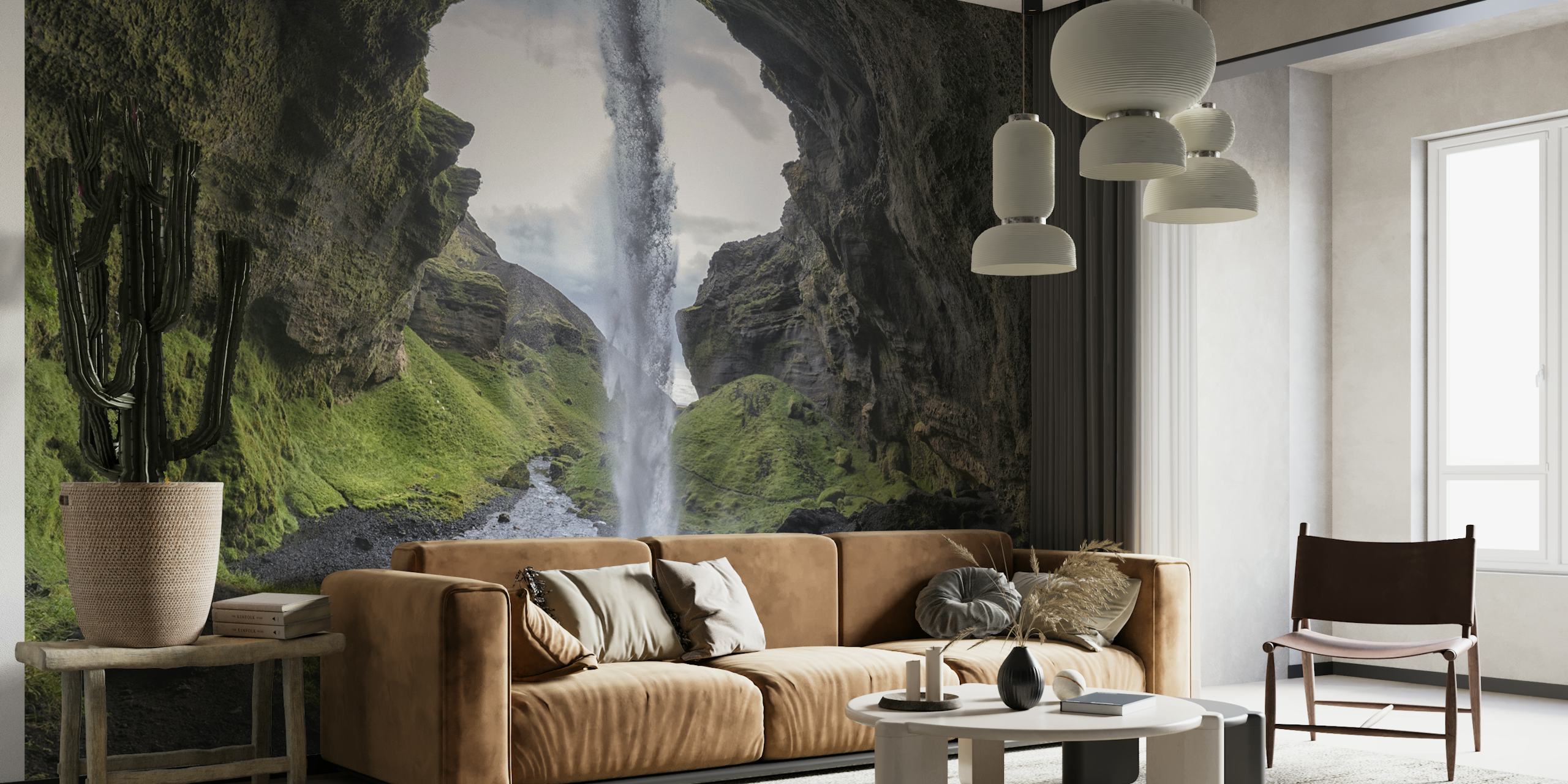 Cascading waterfall framed by rock formations and grass wallpaper