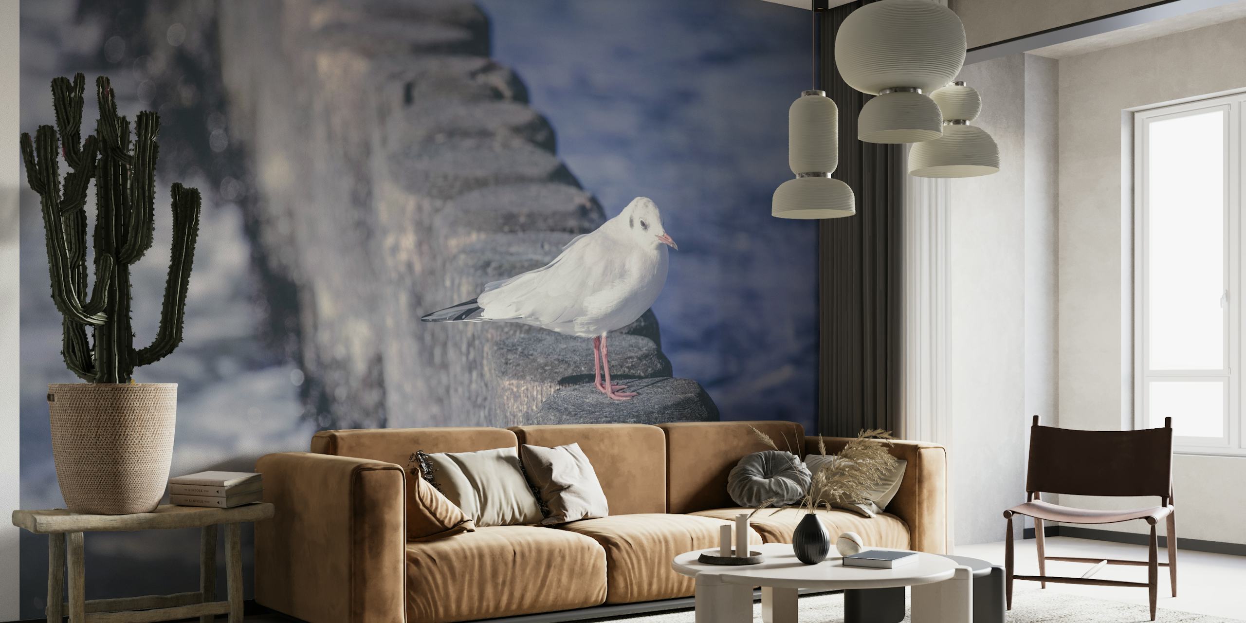 Seagull perched on a stone pier against a blurred ocean background in the 'Seagull Relaxing' wall mural