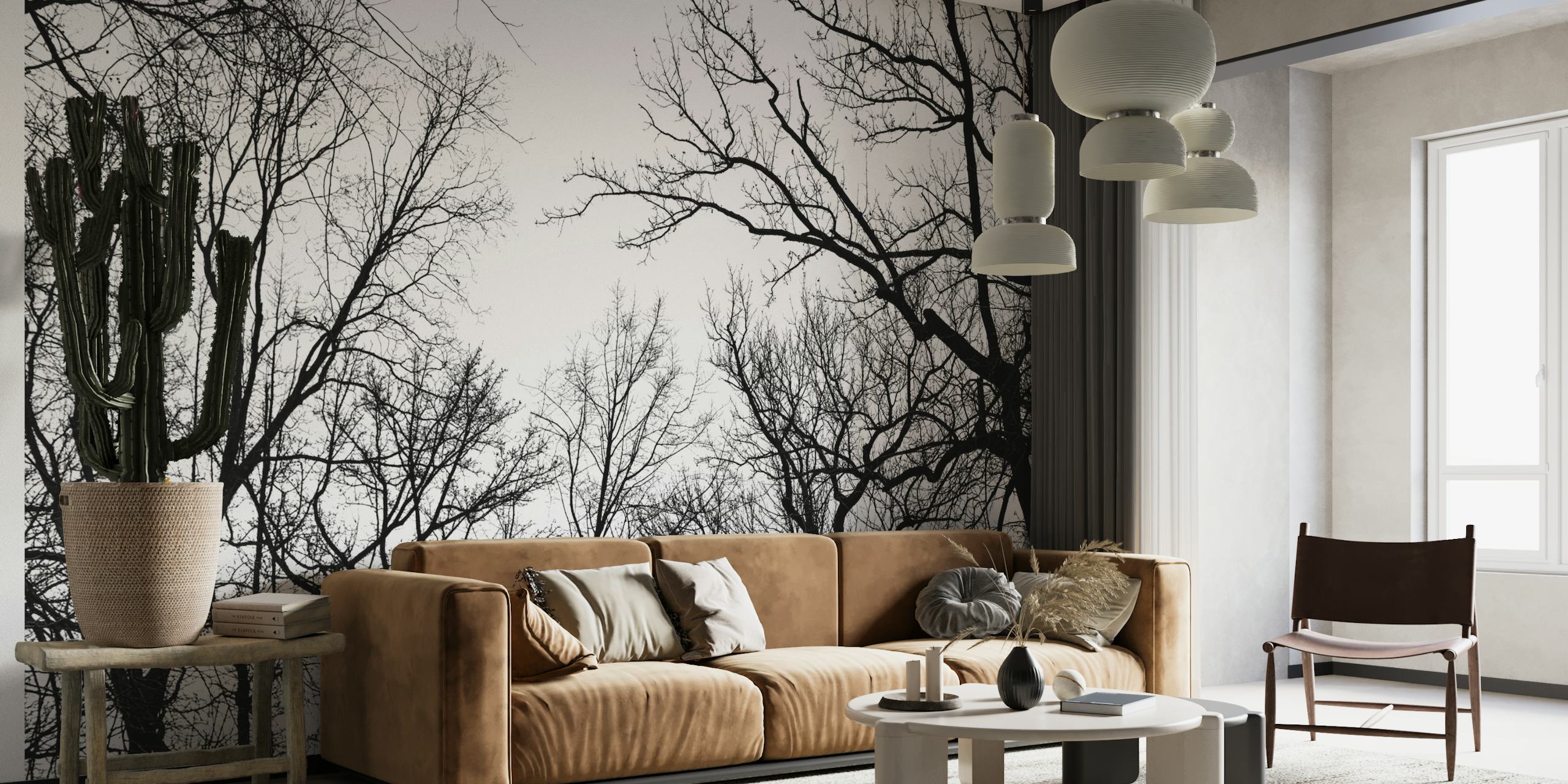 Black and white wall mural of tree branches against an overcast sky