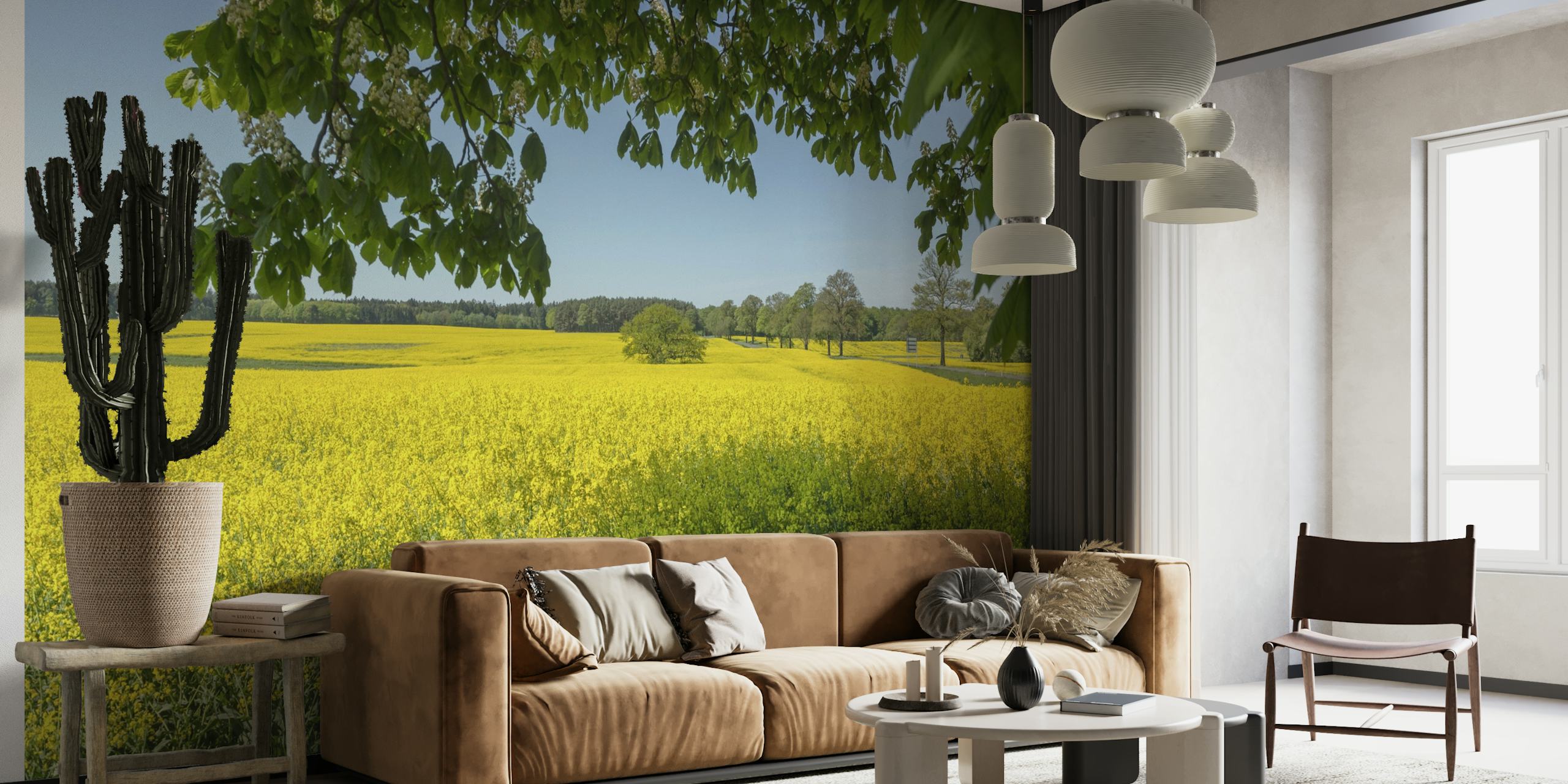 Rapeseed Field with lush green trees and clear blue sky wall mural
