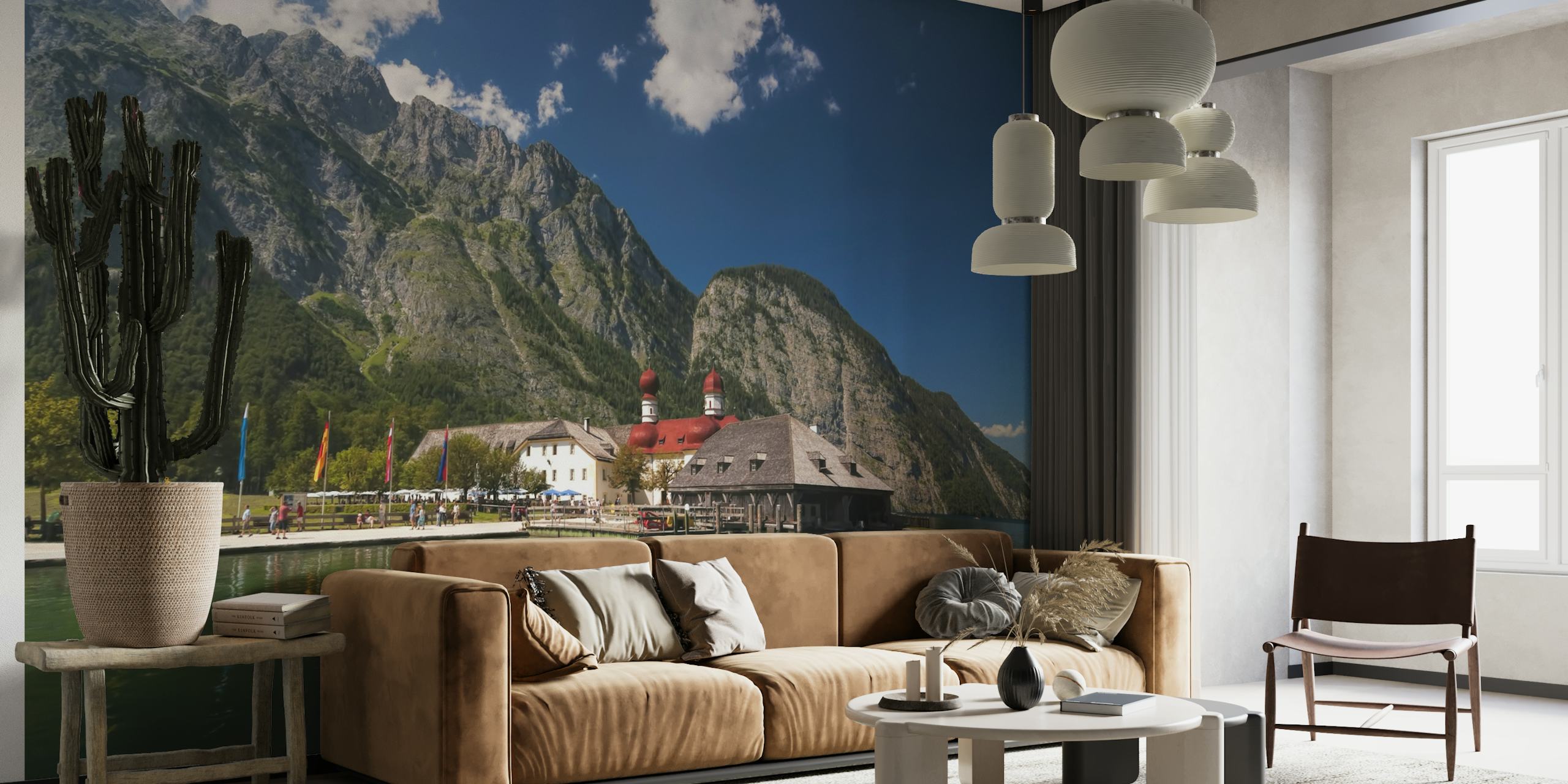 Picturesque lake view wall mural with mountains, clear sky, and a building by the waterfront.
