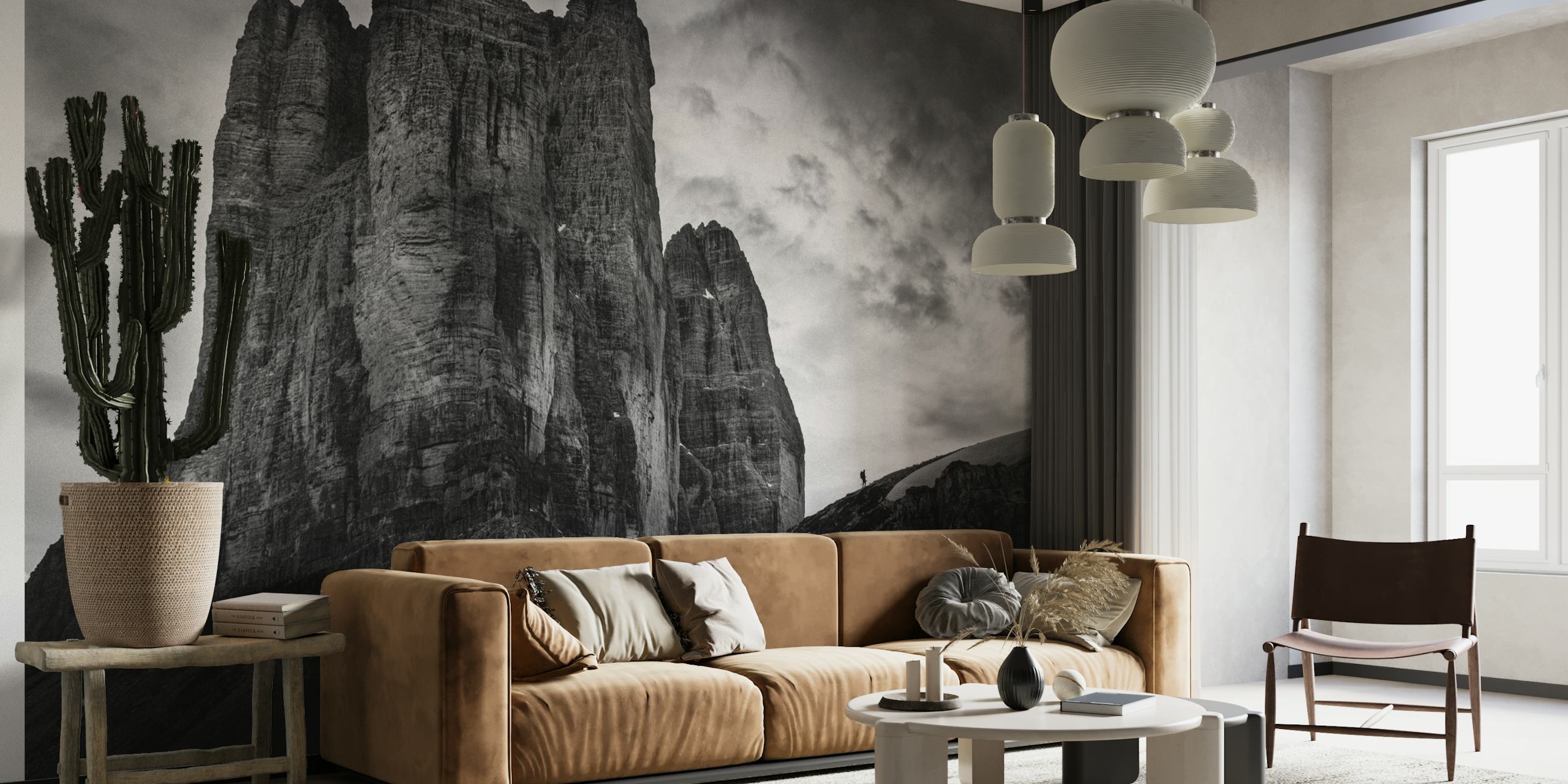 Black and white wall mural of Tre Cime di Lavaredo with a dramatic sky and snow highlights