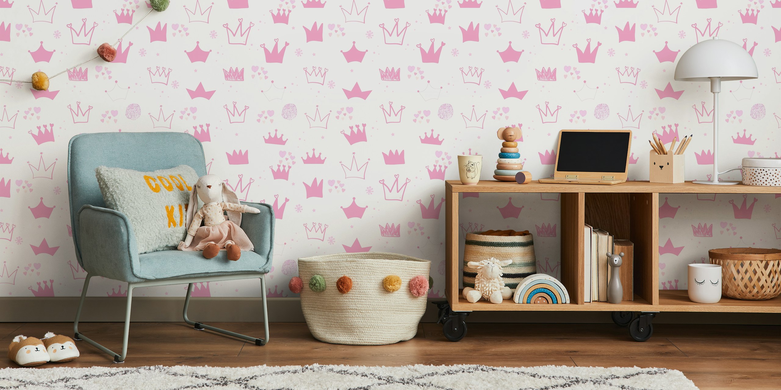 Hand-drawn crowns and hearts pattern wall mural in pink hues for a baby girl's room