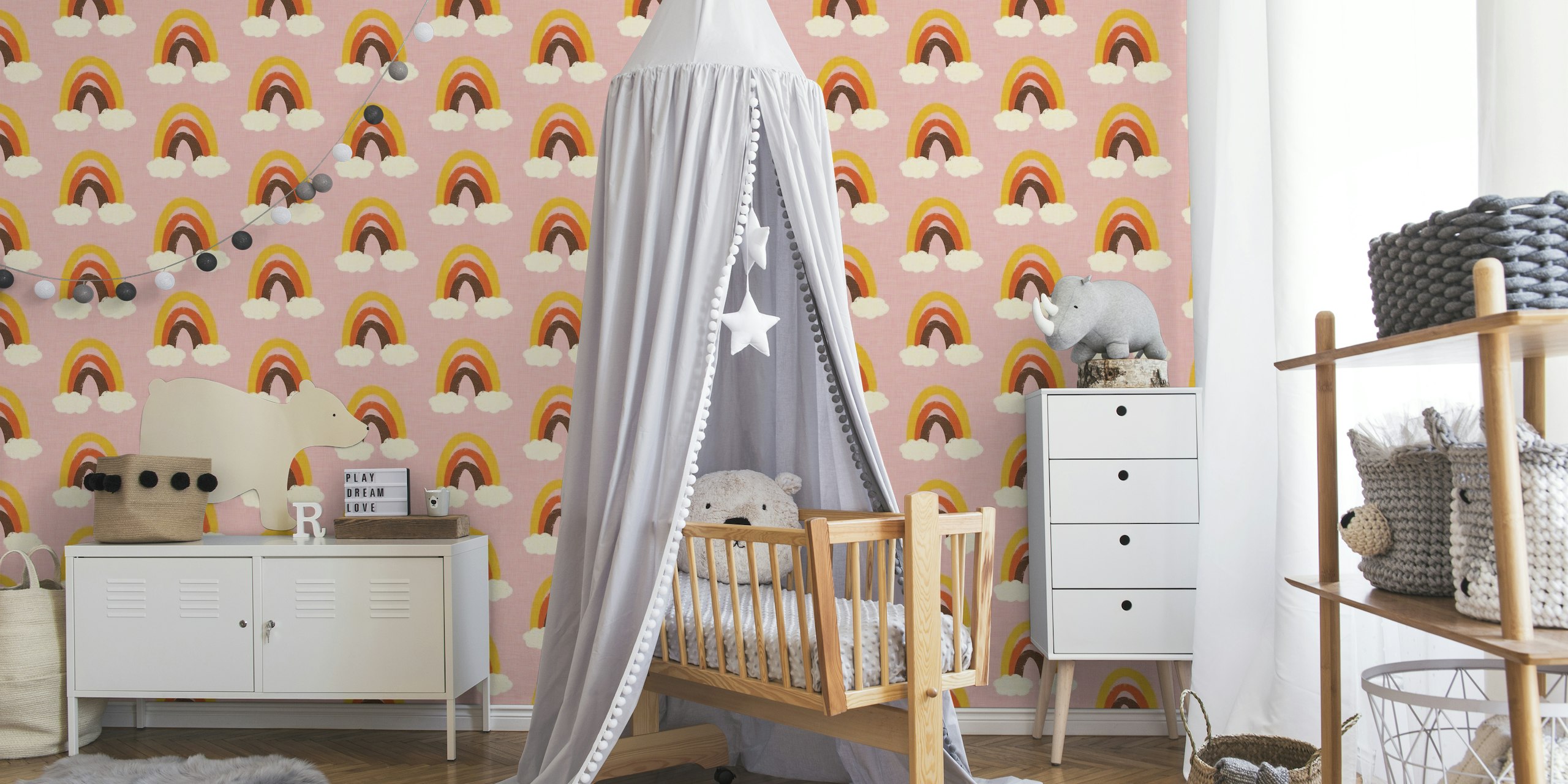 A pattern of cute rainbows with clouds on a pink background wall mural