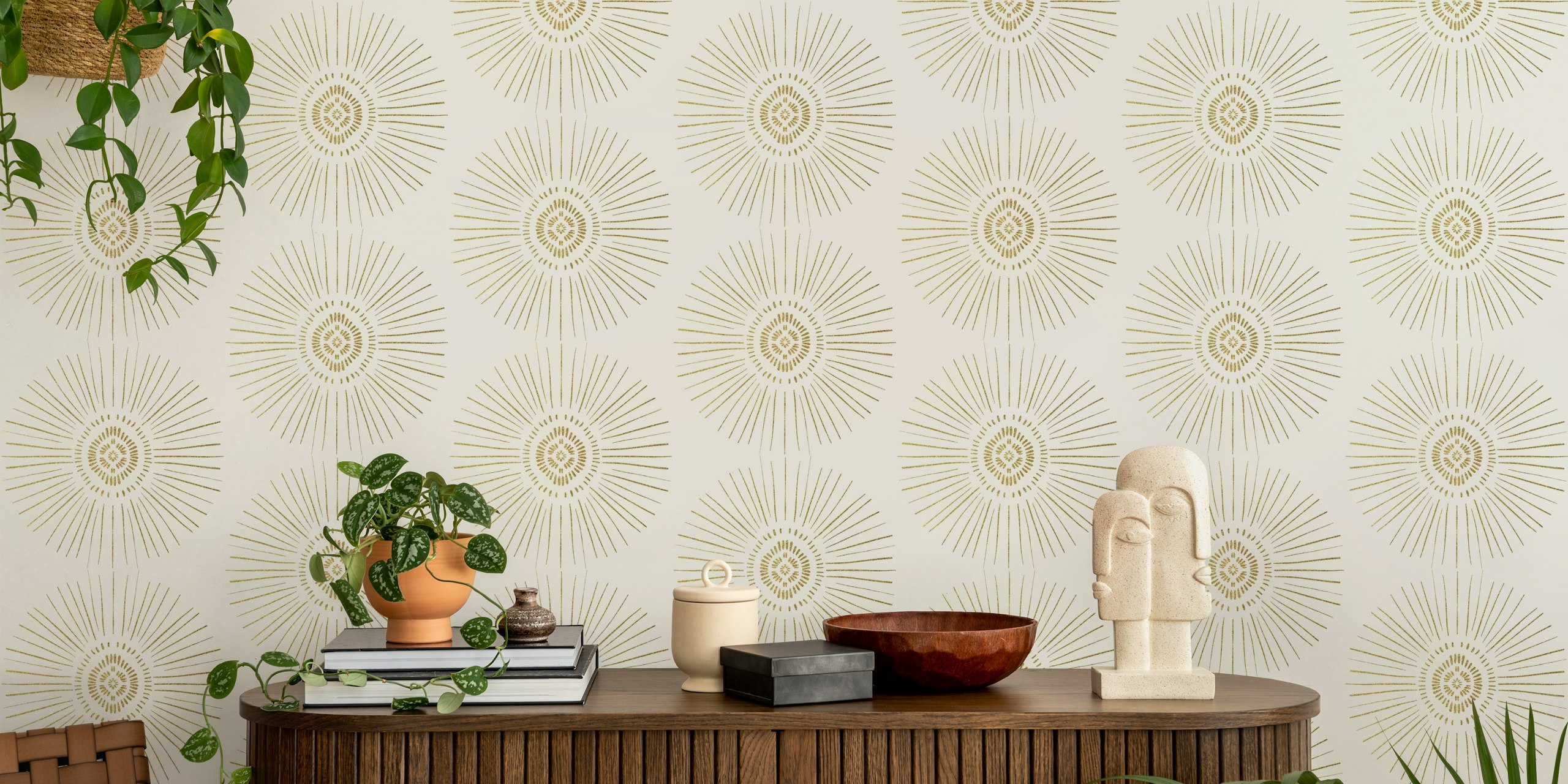Gold tribal sun symbols with radiating lines on cream wallpaper