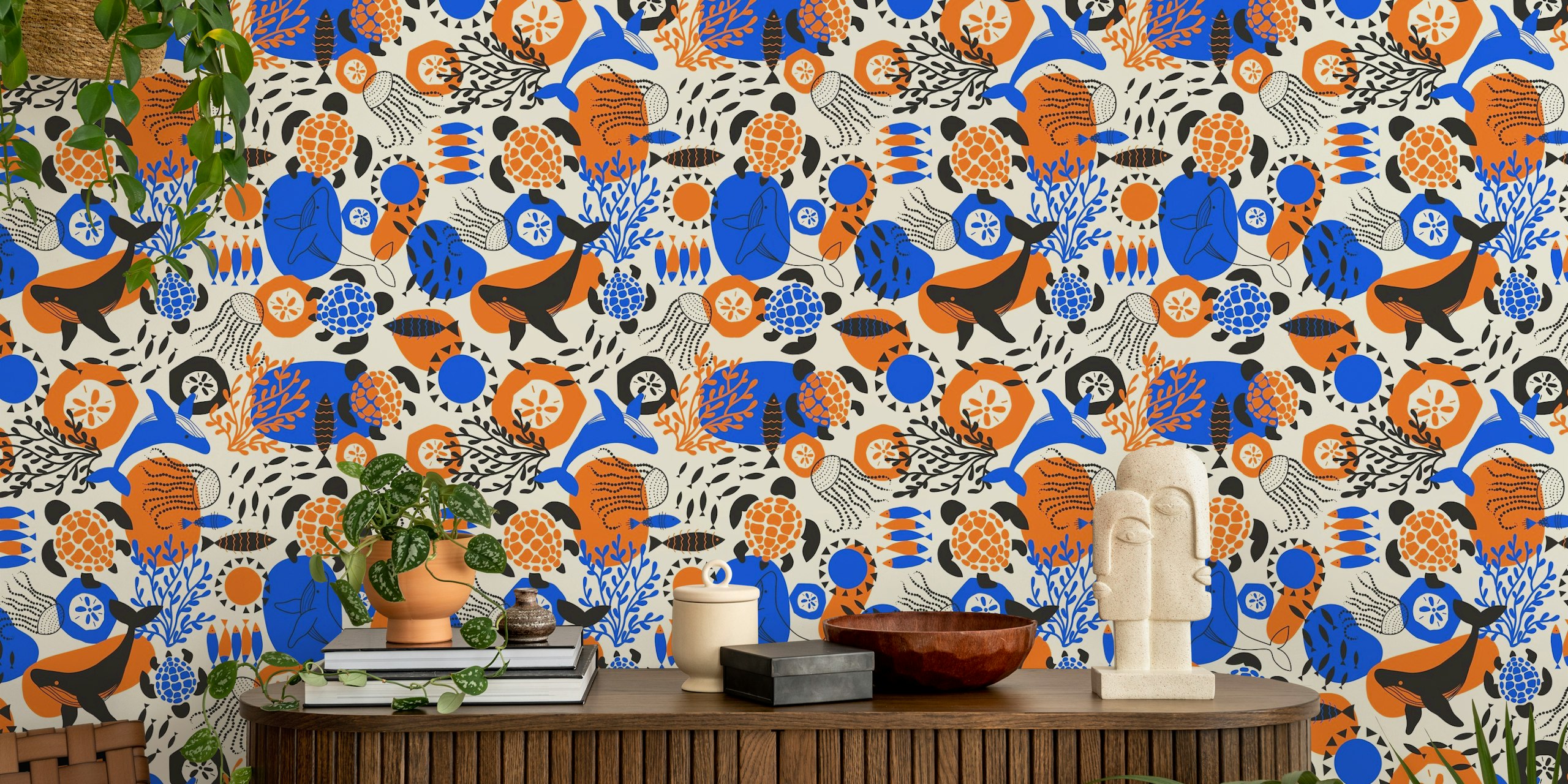 Ocean animals like whales and turtles in vibrant blue, orange, and black on cream wallpaper