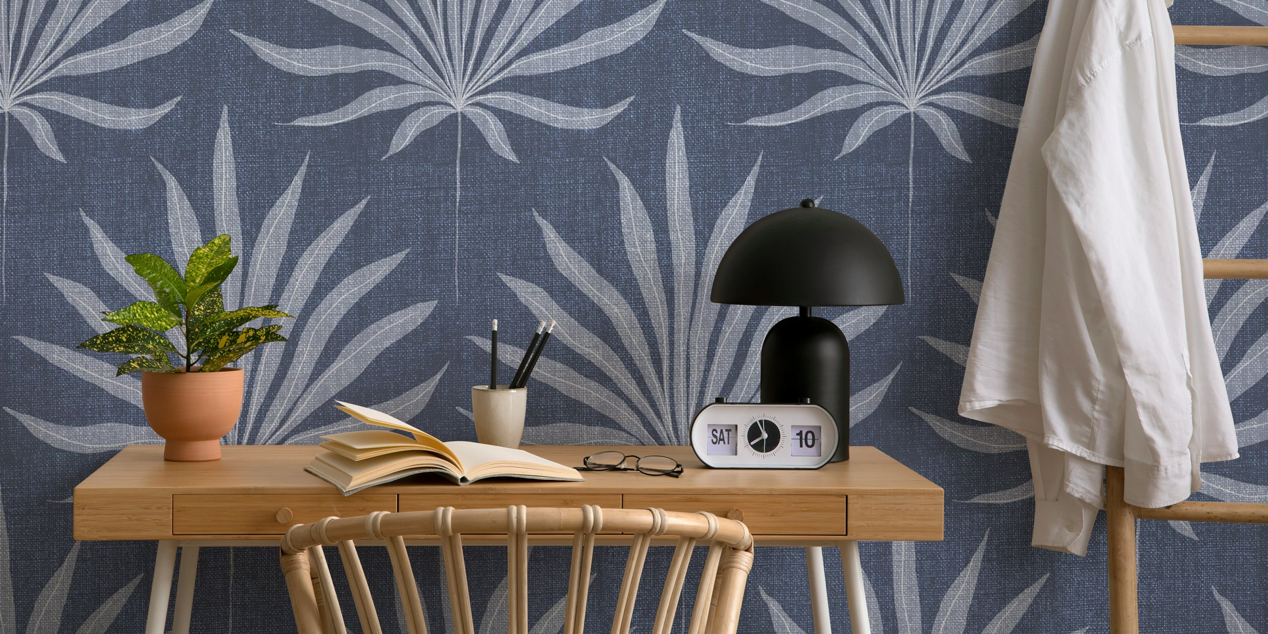 Denim blue palm frond wallpaper in a room