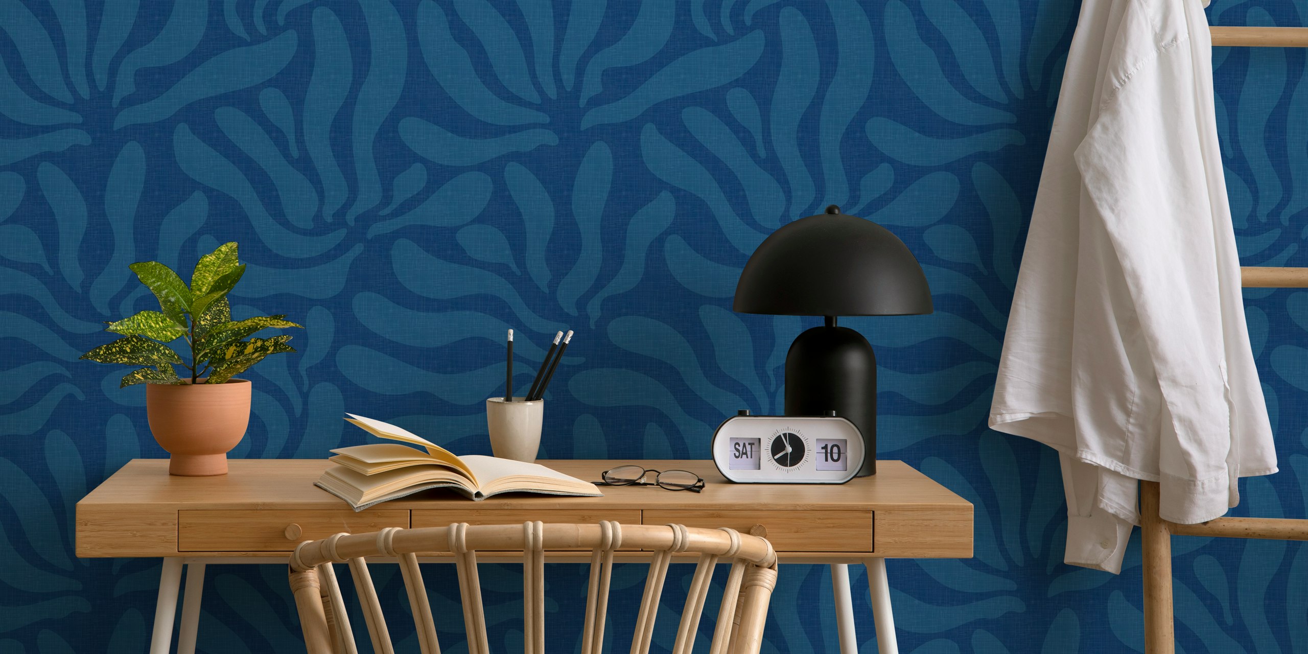 Ocean blue flowing leaves wallpaper in a room