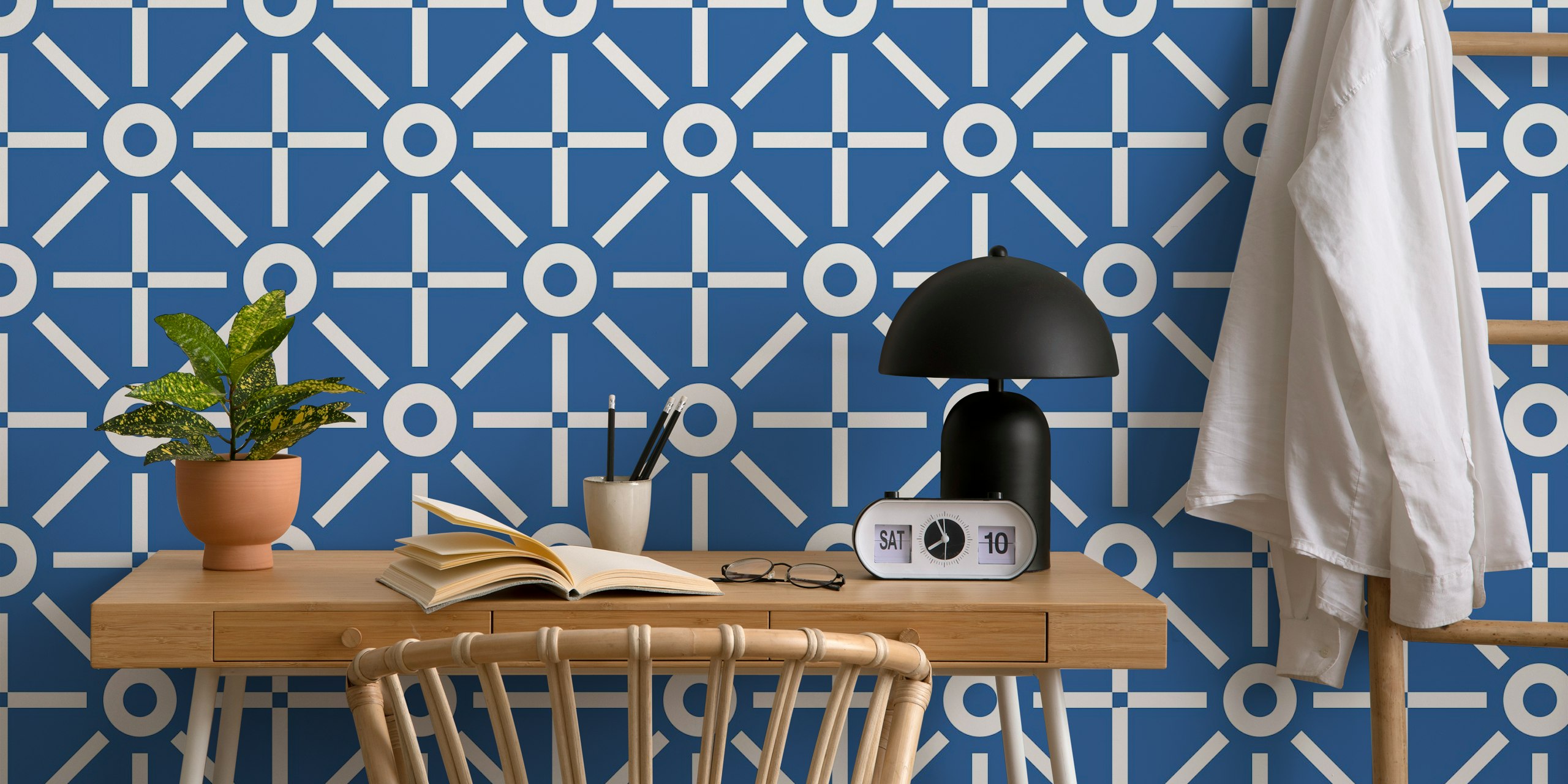 Blue geometric pattern wallpaper featuring white shapes.