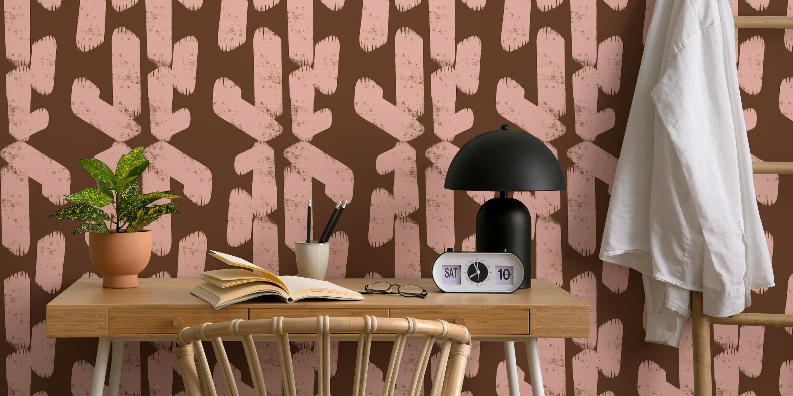 Geometric shapes in pink and brown on textured wallpaper