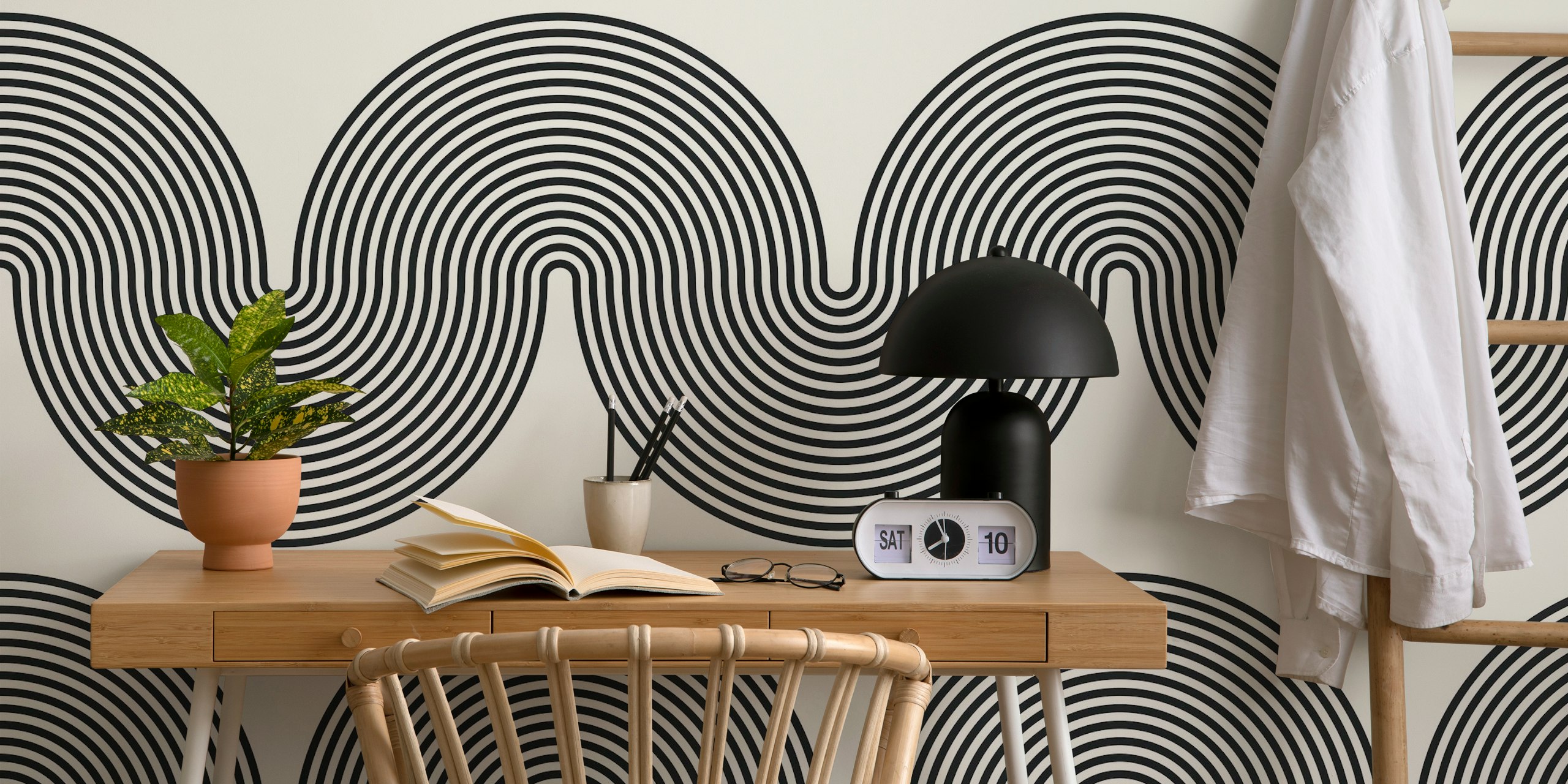 Black and white geometric patterned wallpaper featuring curved lines