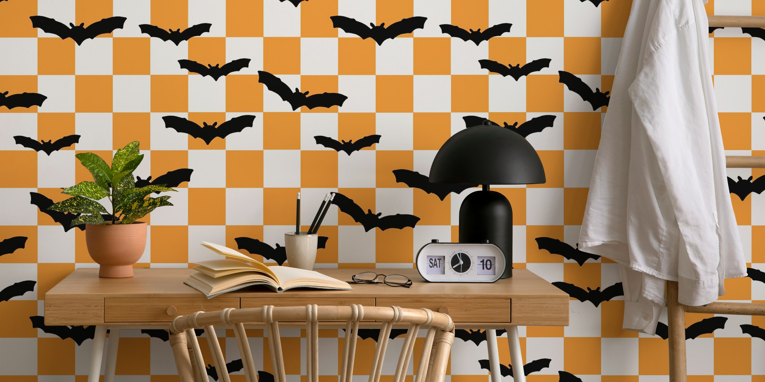 Black bats on an orange and white checkerboard wallpaper