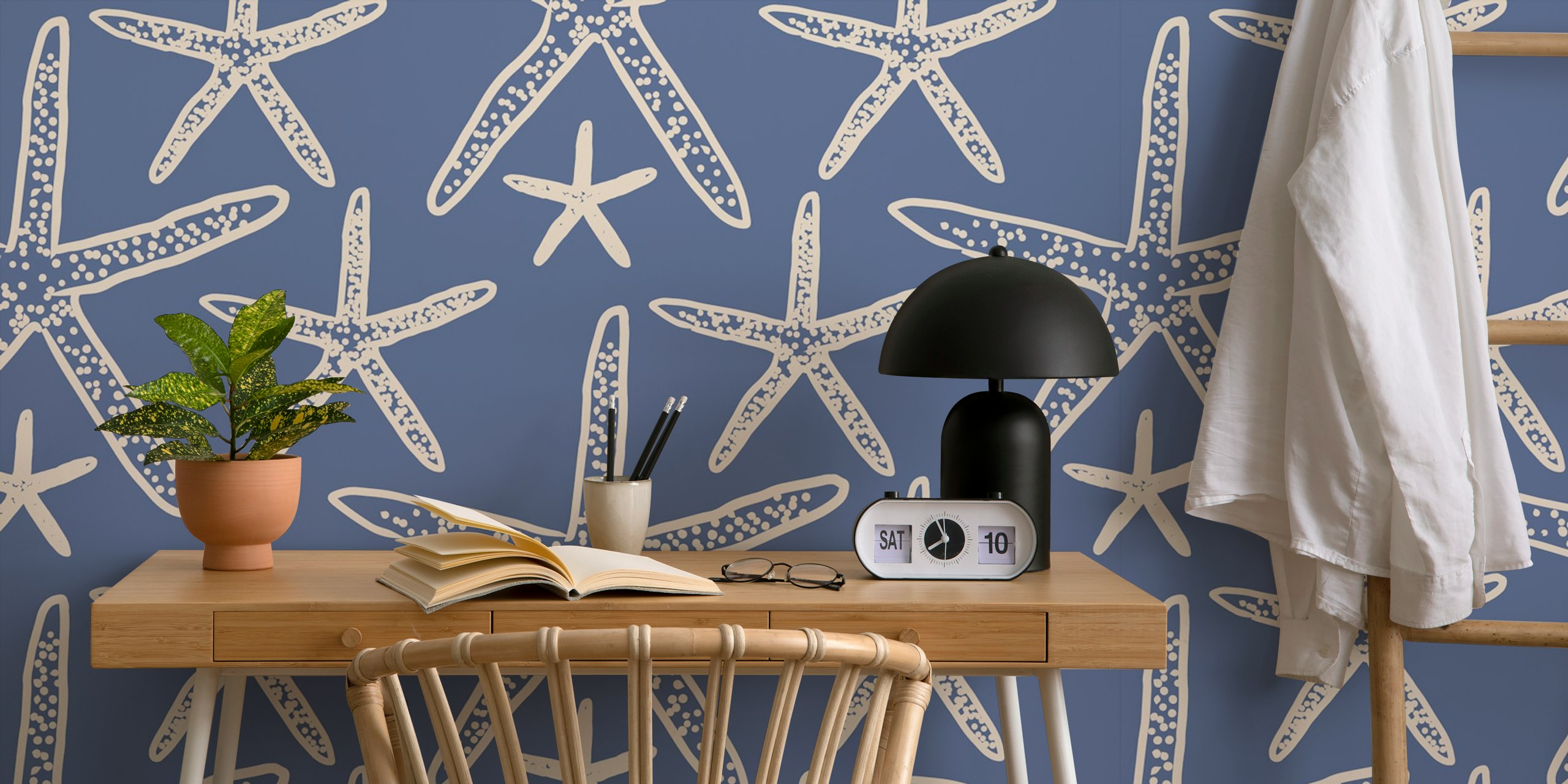 Blue starfish pattern against a navy background wallpaper