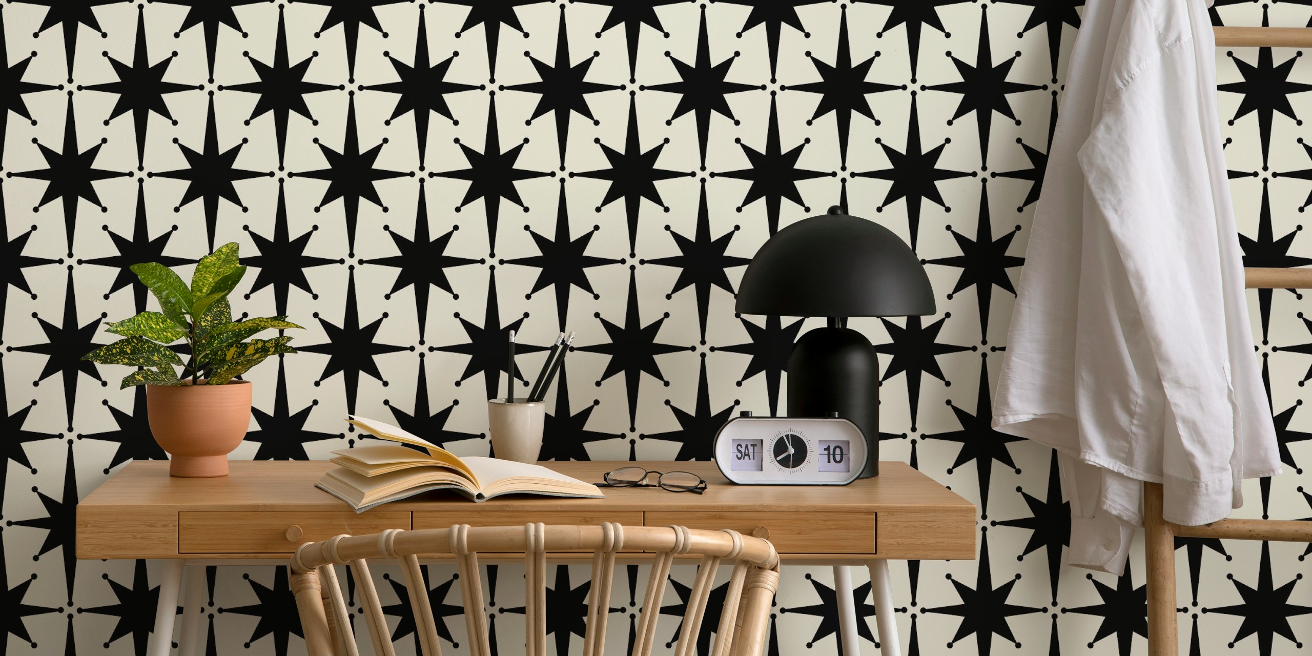 Black starburst shapes on cream background wallpaper