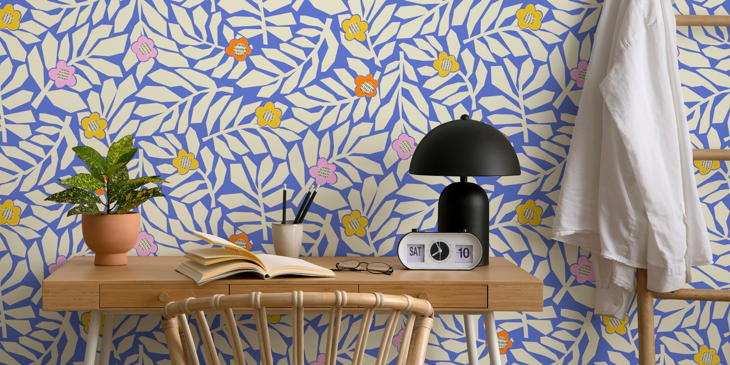 Leaves and pastel blossoms pattern on blue wallpaper