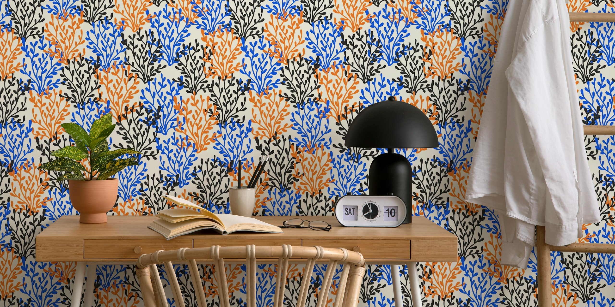 Colorful floral pattern in blue, orange, and black on cream background wallpaper