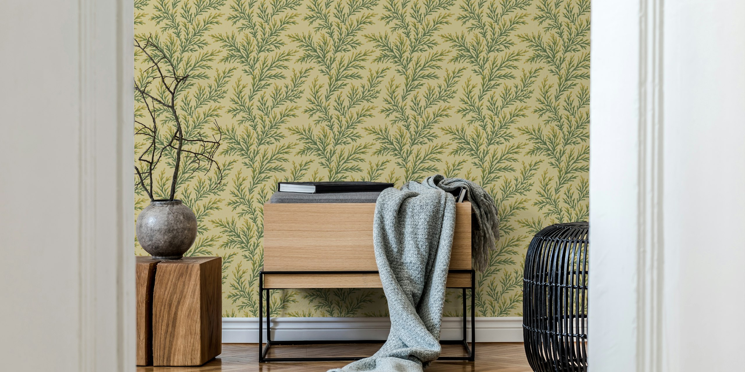 Green pine branches on a pale yellow background wallpaper