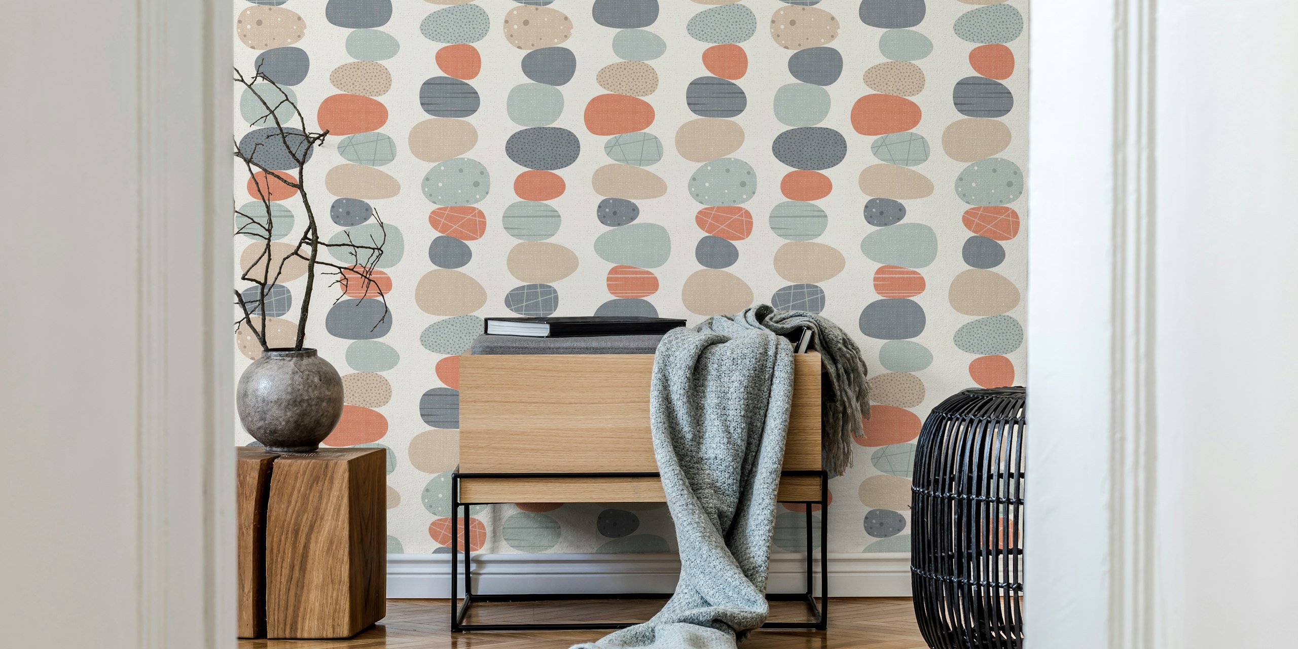 Colorful pebble stones in soft pastels on cream wallpaper