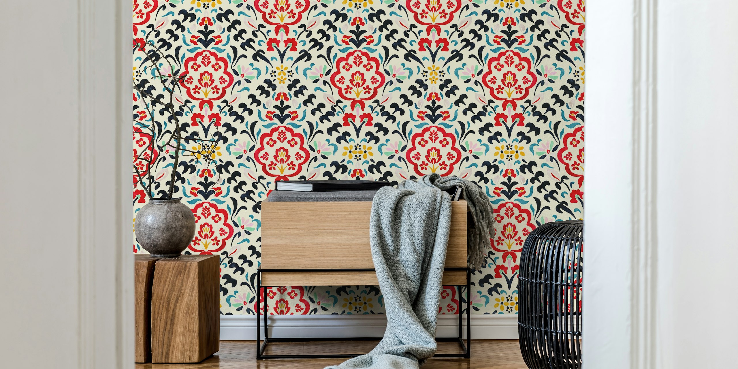Multicolored floral patterns in red, blue, and gold on cream wallpaper