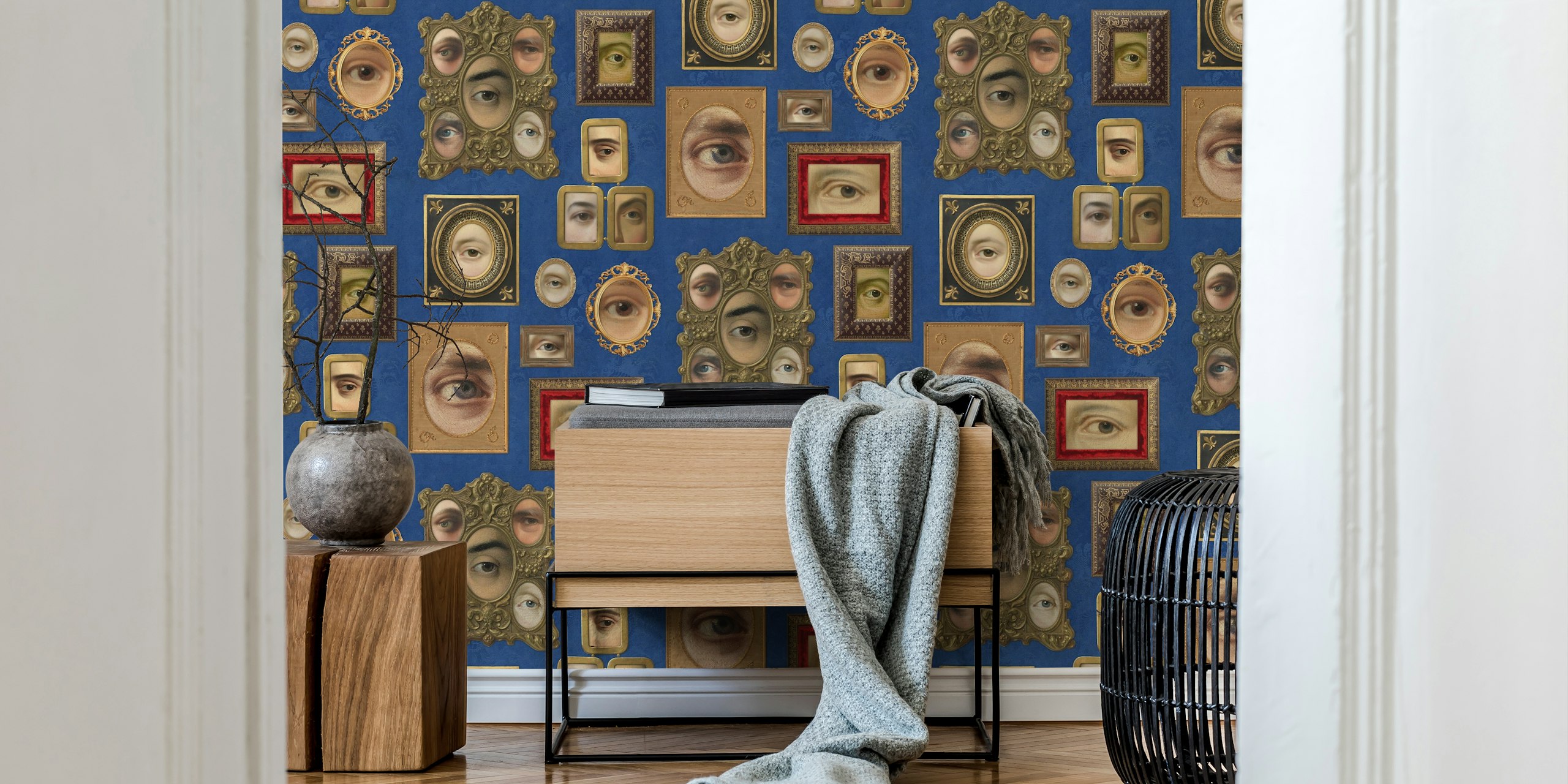 Victorian eye portraits in ornate frames against cobalt blue wallpaper