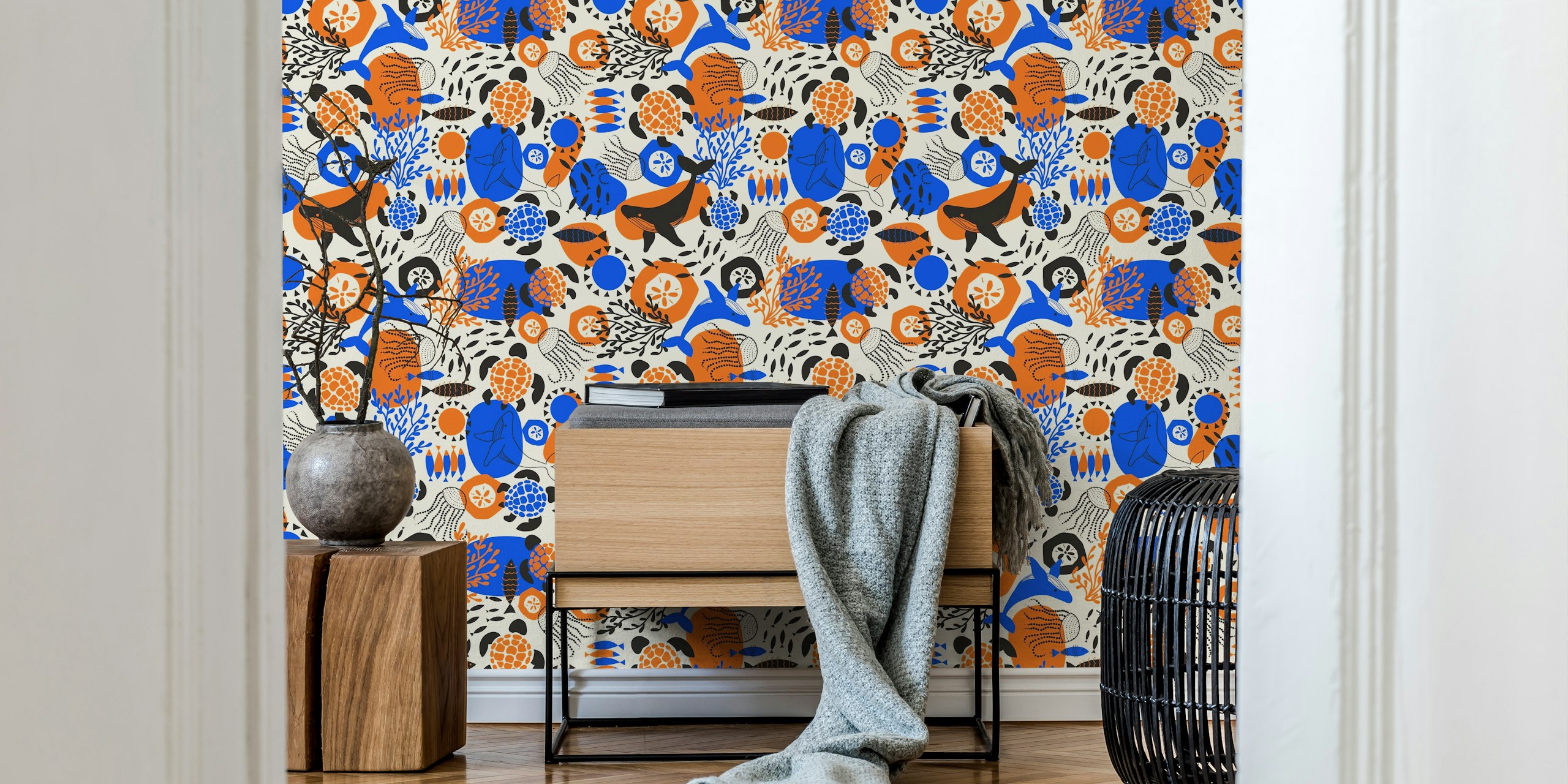Ocean animals like whales and turtles in vibrant blue, orange, and black on cream wallpaper