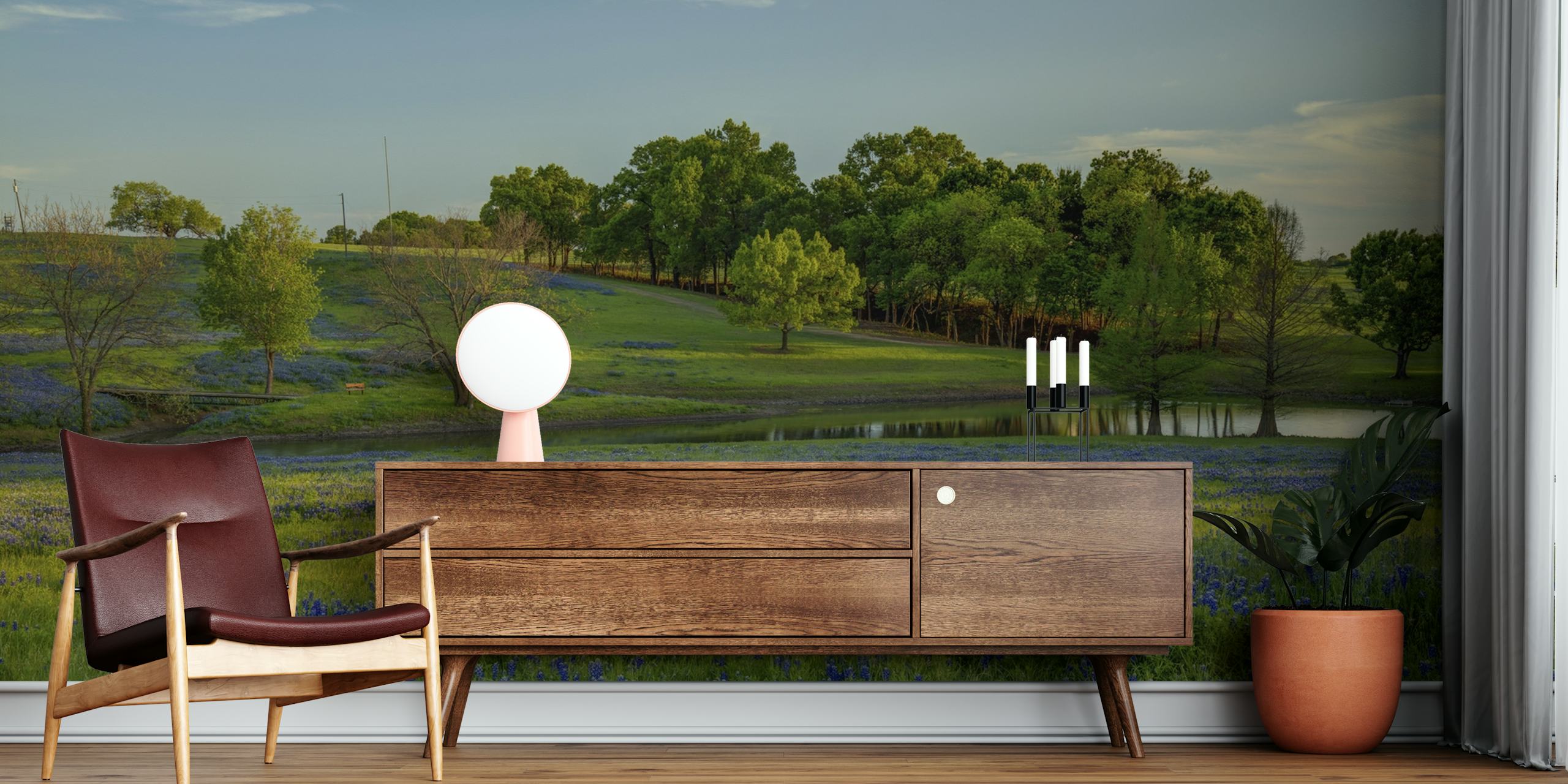 Blue floral patterns over green grass wallpaper